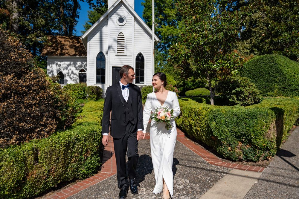Bride and Groom walking away from Oaks Pioneer Church