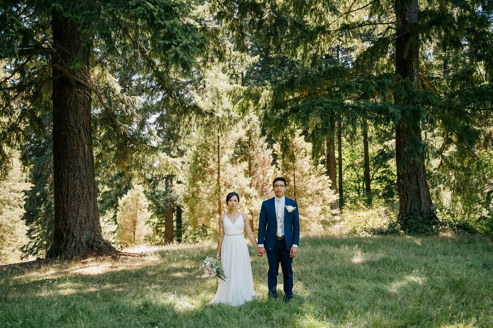 Bride and Groom standing in field at Washington Park