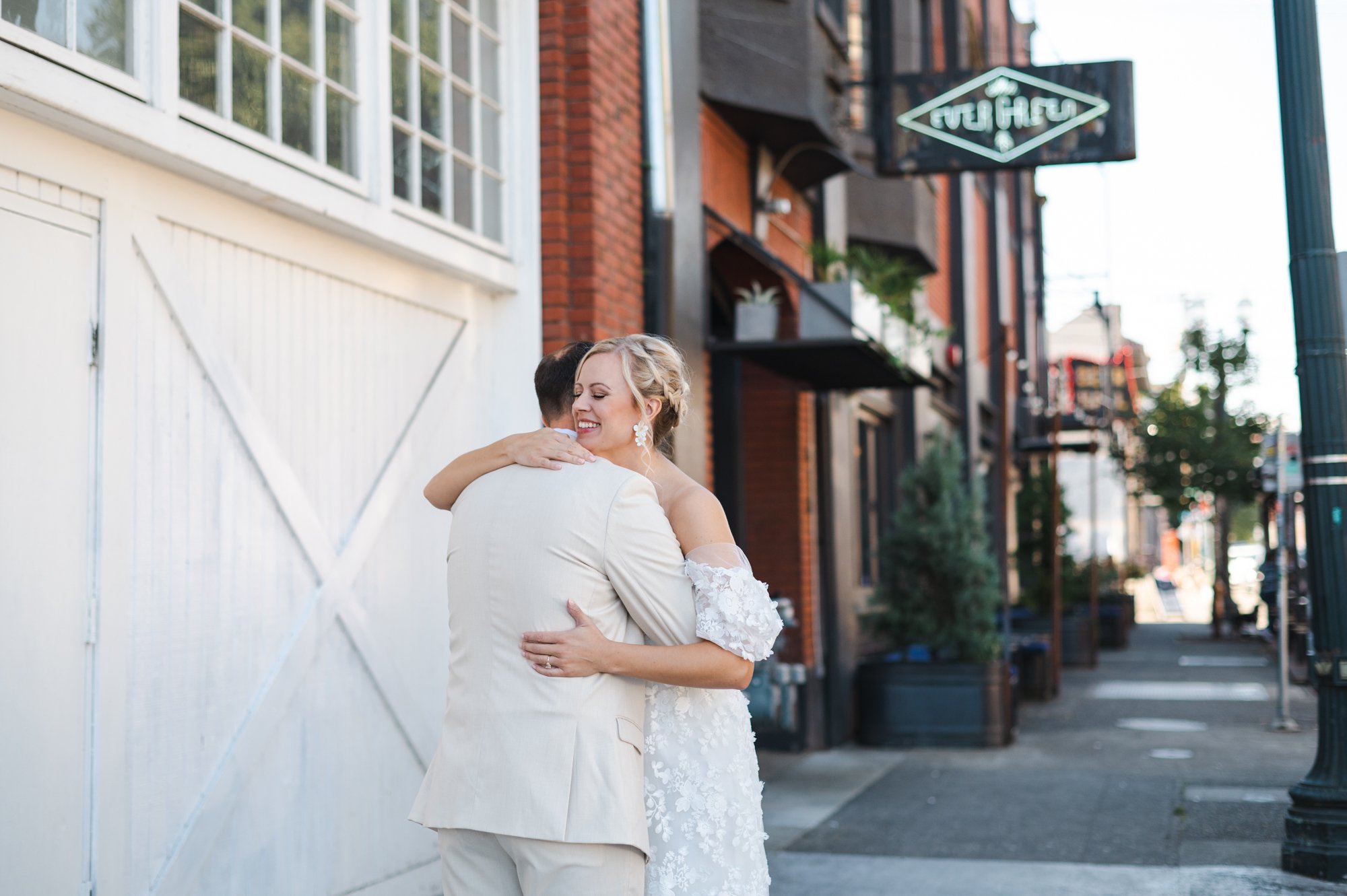 Couple hugging outside of The Evergreen in Portland