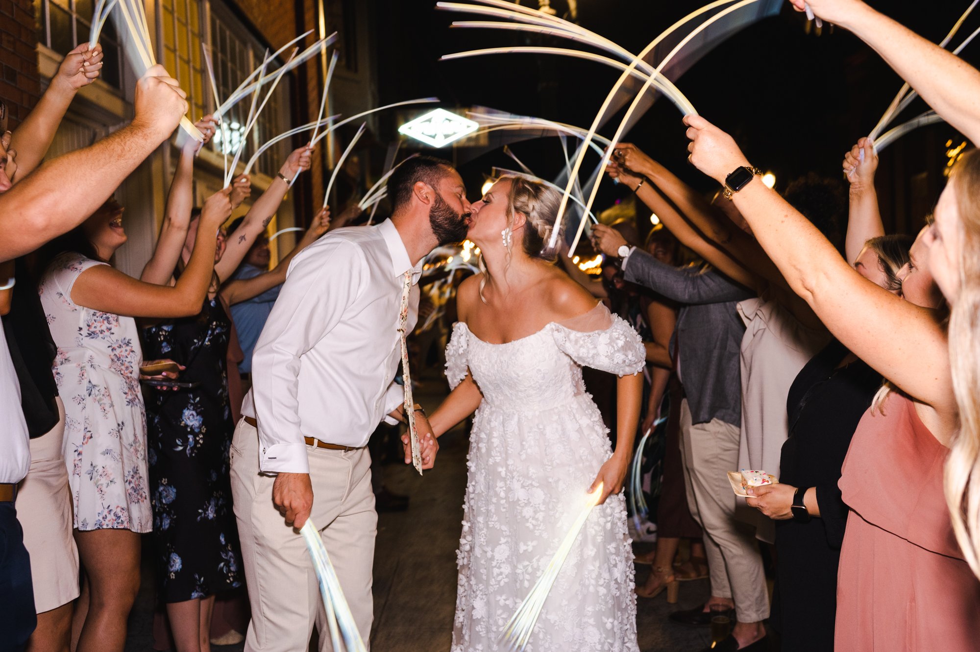 Bride and Groom kiss during glow stick send off