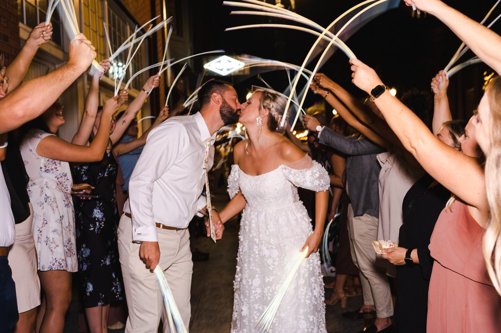 Bride and Groom kiss during glow stick send off