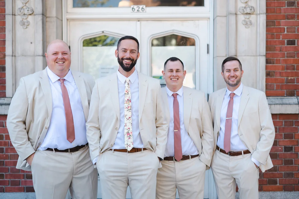 Groomsmen portrait in front of building