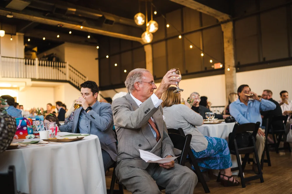 Father of the bride holding up glass