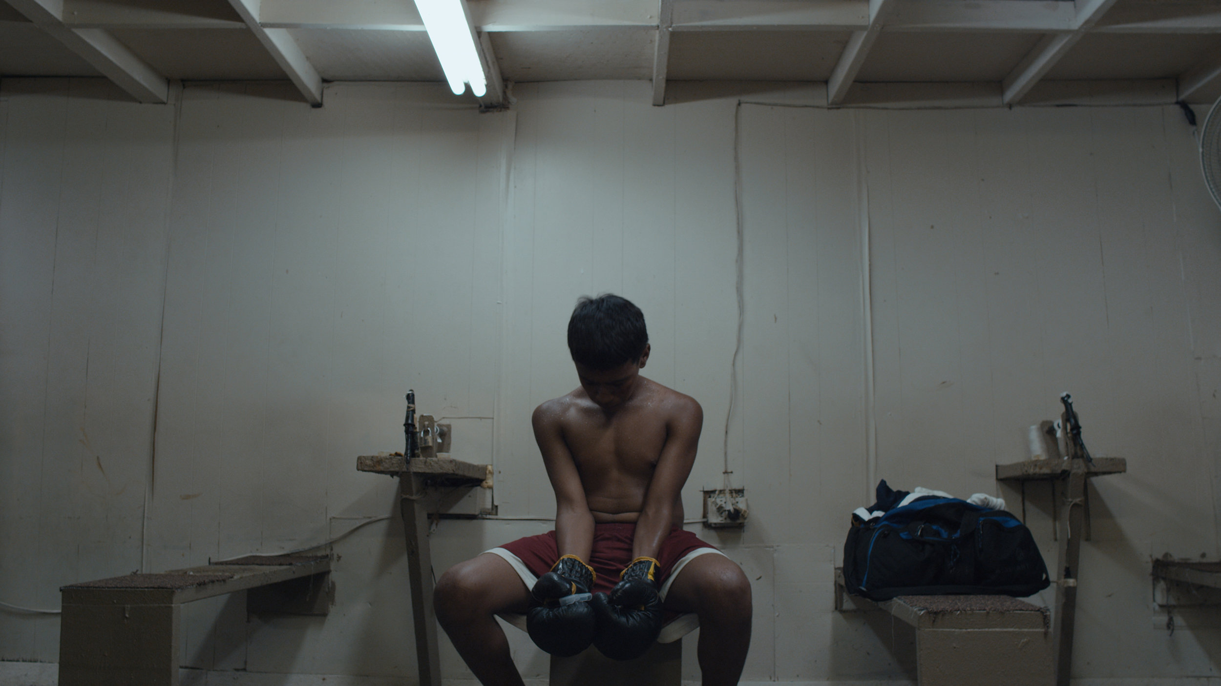 LA GRANJA A film by Angel Manuel Soto (Puerto Rico, 2015, 100 min. In Spanish with English subtitles) In the small sector of a Macondo-like island forgotten by the catastrophic effects of an economic depression and drug addiction, lives are pushed to the limit. A promising young boxer, a barren midwife, and a fat kid with a bike: three intersecting stories focus around the pursuit of happiness and its unanticipated consequences during the economic collapse of the island of Puerto Rico. Each actor in this modern day tragedy will ultimately discover how the pursuit of hope can dehumanize and expose underlying animal instincts. Winner of the Best First Film Award at the Guadalajara Film Festival and nominated for Best Foreign Language at the UK National Film Academy, La Granja held its world premiere at Fantastic Fest and had a successful film festival run playing at Tribeca, Raindance, Miami, among others. Soto’s acclaimed debut feature offers a timely and electrifying portrayal of the hardships and hopelessness of life in modern Puerto Rico, and heralds the arrival of an exciting new voice in Puerto Rican cinema. 