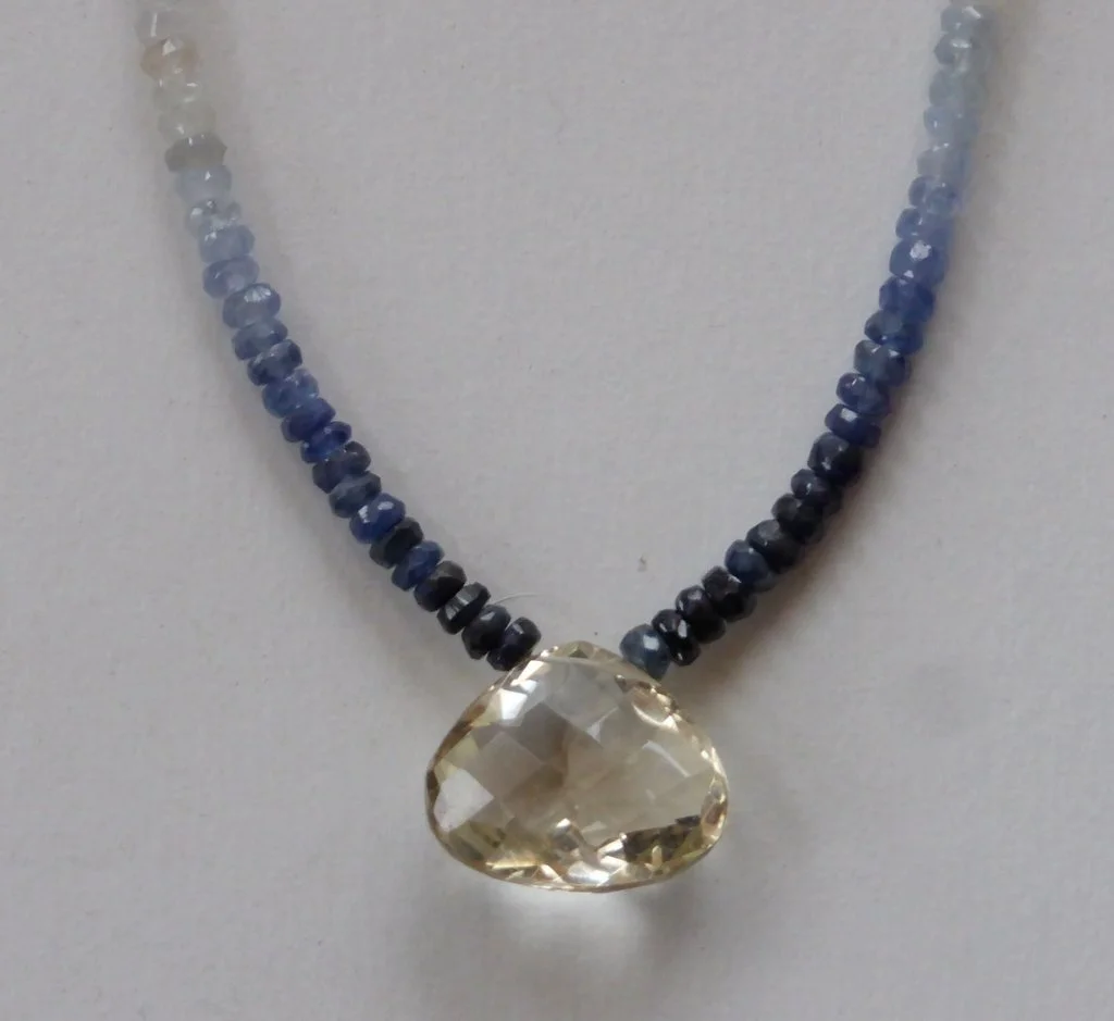 shaded sapphire necklace with faceted lemon quartz drop