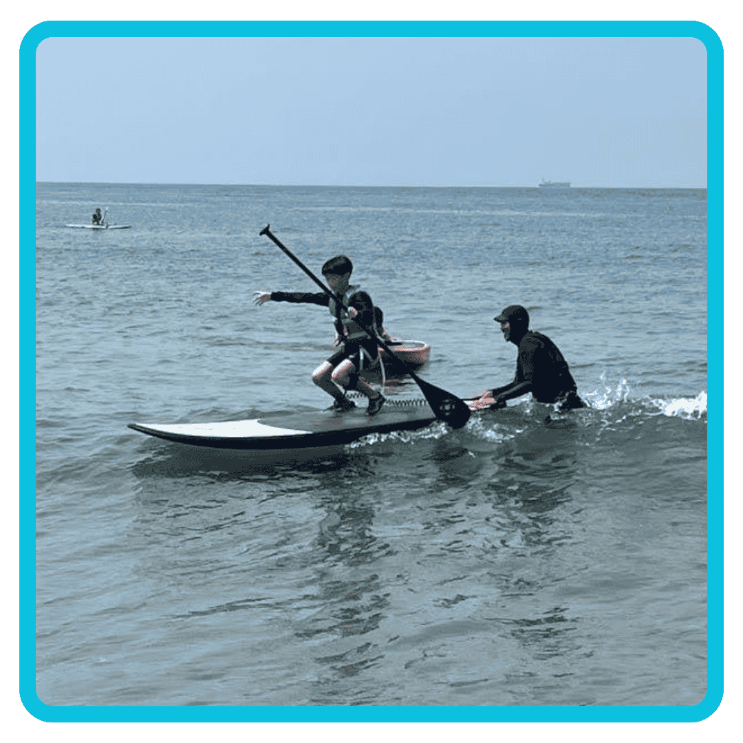 Kids learning how to SUP at Summer Camp