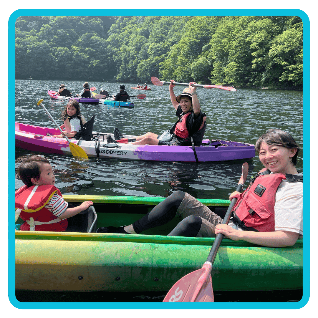Kids and parents working together on kayak tour on lake