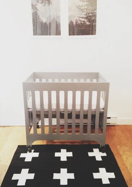 We decided on a mini crib for obvious size constraints. The babyletto grayson was our pick. The style is clean and simple and has proven to be quite sturdy. I had big dreams of turning one of our closets into a nursery until measurements proved that all our closets were too small (oh tiny living!). One added benefit of a mini crib is it fits pack and play sheets which tend to be cheaper and take up less storage space. I had visions of packing it away when not in use but turns out that is not something you have the time or energy to do when a new baby takes all your time (seriously the days fly by with no tangible tasks completed). crib: babyletto (similar) // rug: pattern society // art: blue window creative