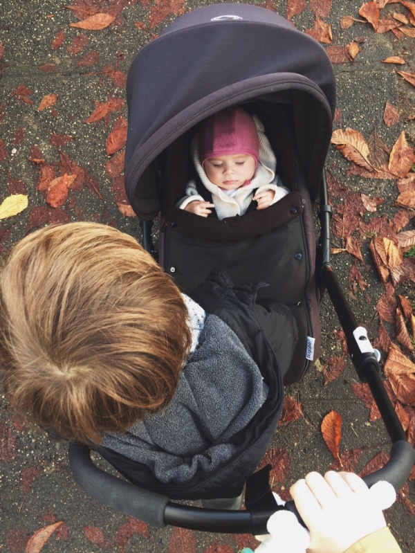 Theo on the "Scooter". Mae (uncharacteristically) asleep in her cozy Simply Merino hat
