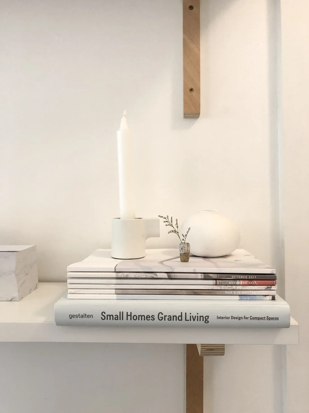 A small stack of photo magazines with the Kid Art one on top (Shelf at our Entryway)
