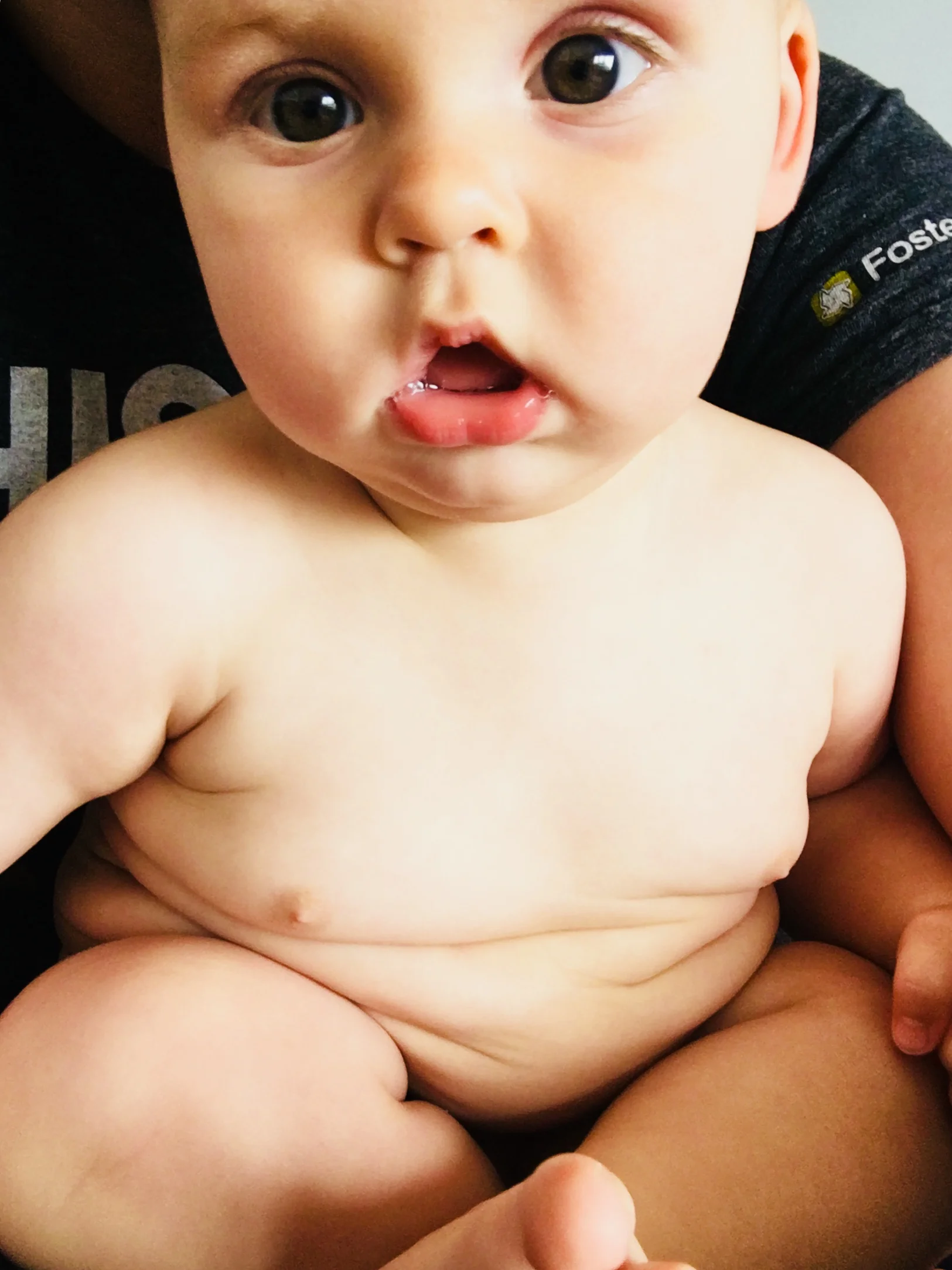 The rolls are still magnificent, and now he has two tiny teeth to go with them.
