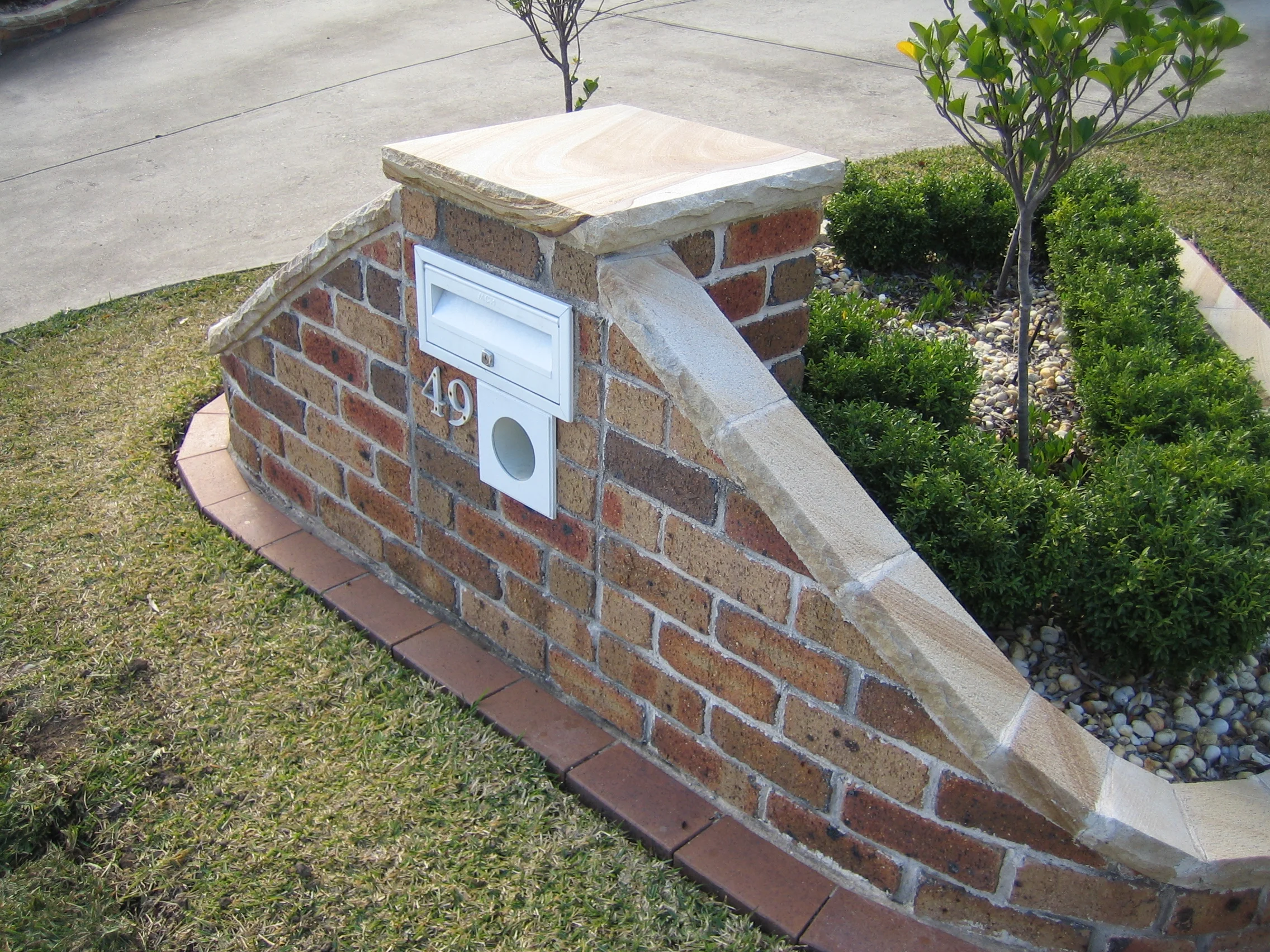 062 sandstone cupping on top of the letterbox and brick wall.jpg