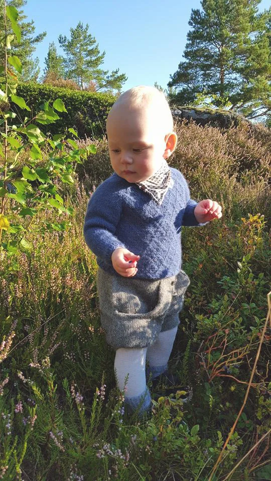 Hverdagsgenser i tynn alpakka og en bunadsshorts uten mønster gir et lekkert og enkelt antrekk