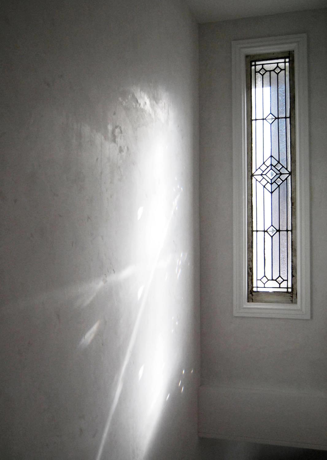 Aesthetic vintage stain glass windows and custom hand finished plaster add a sense of warmth and tactility. 