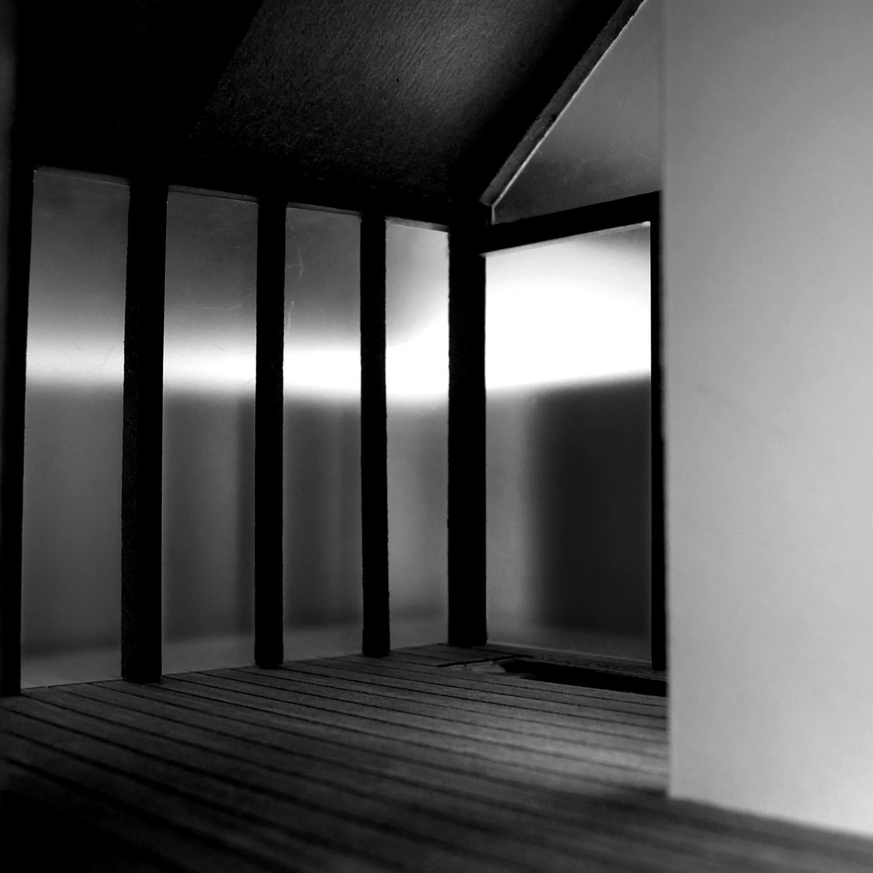 Gallery the steel wall filters softly through, creating a contrast to the glow of reflected light.