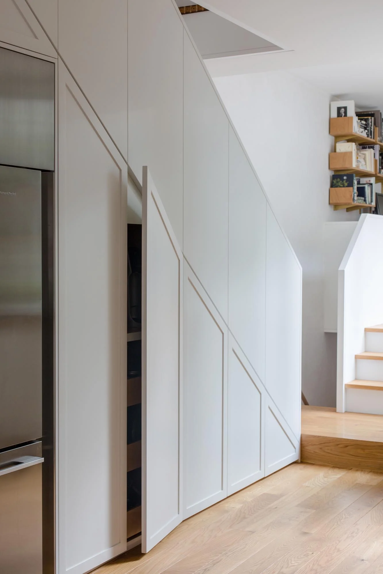  Kitchen &nbsp;&nbsp; cabinets and storage are hidden beneath the staircase, keeping the space clean and free of clutter. 