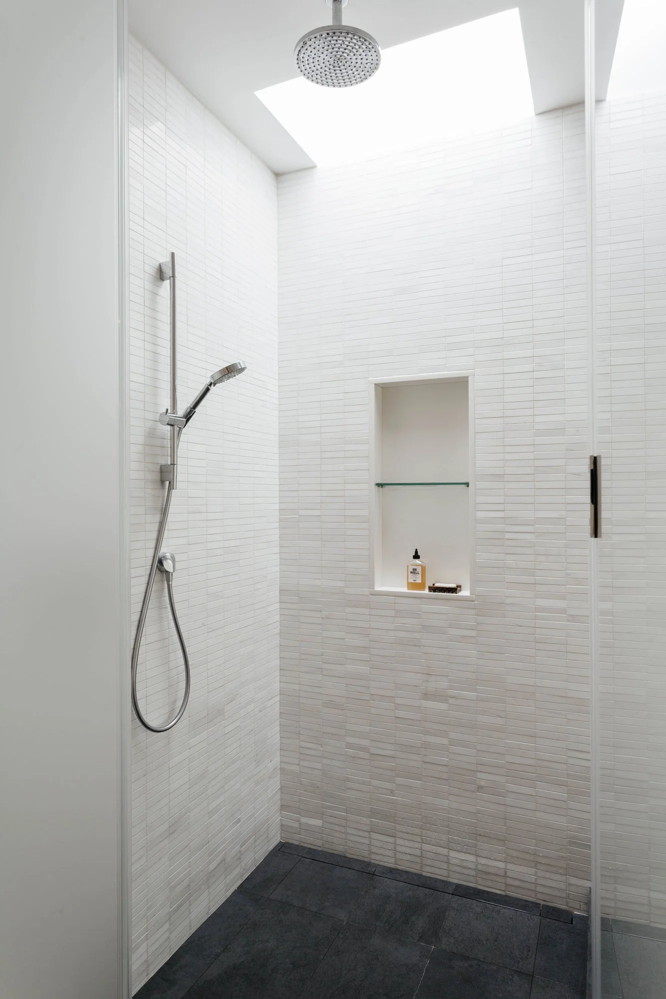   Shower   marble mosaic accented by the operable skylight above 