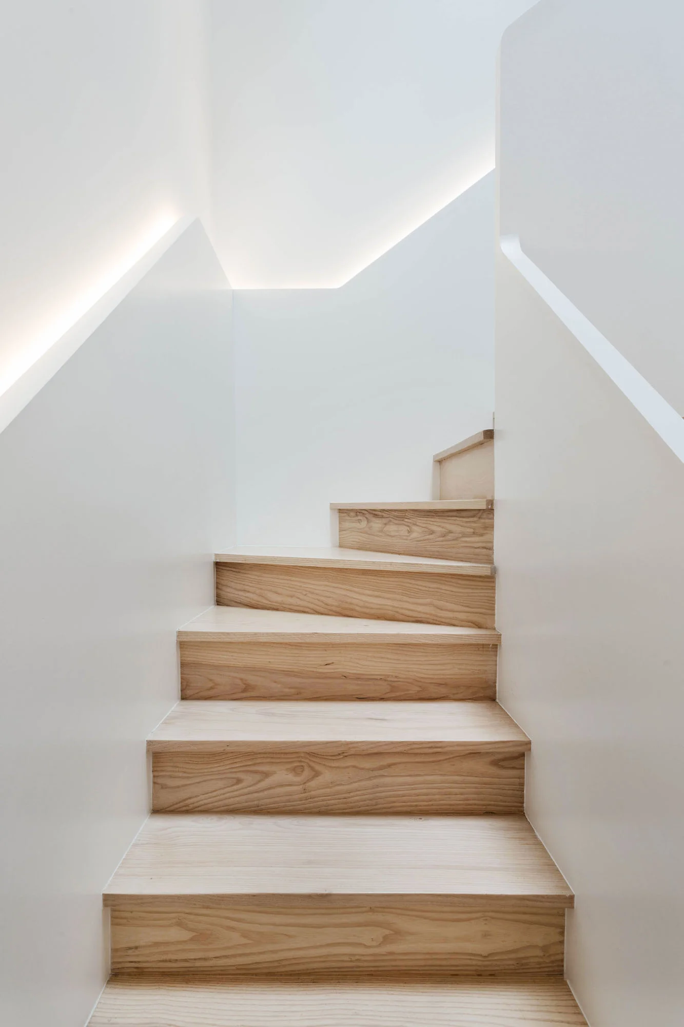   Skylight   the upper flight of stairs softly illuminated by the skylight above 