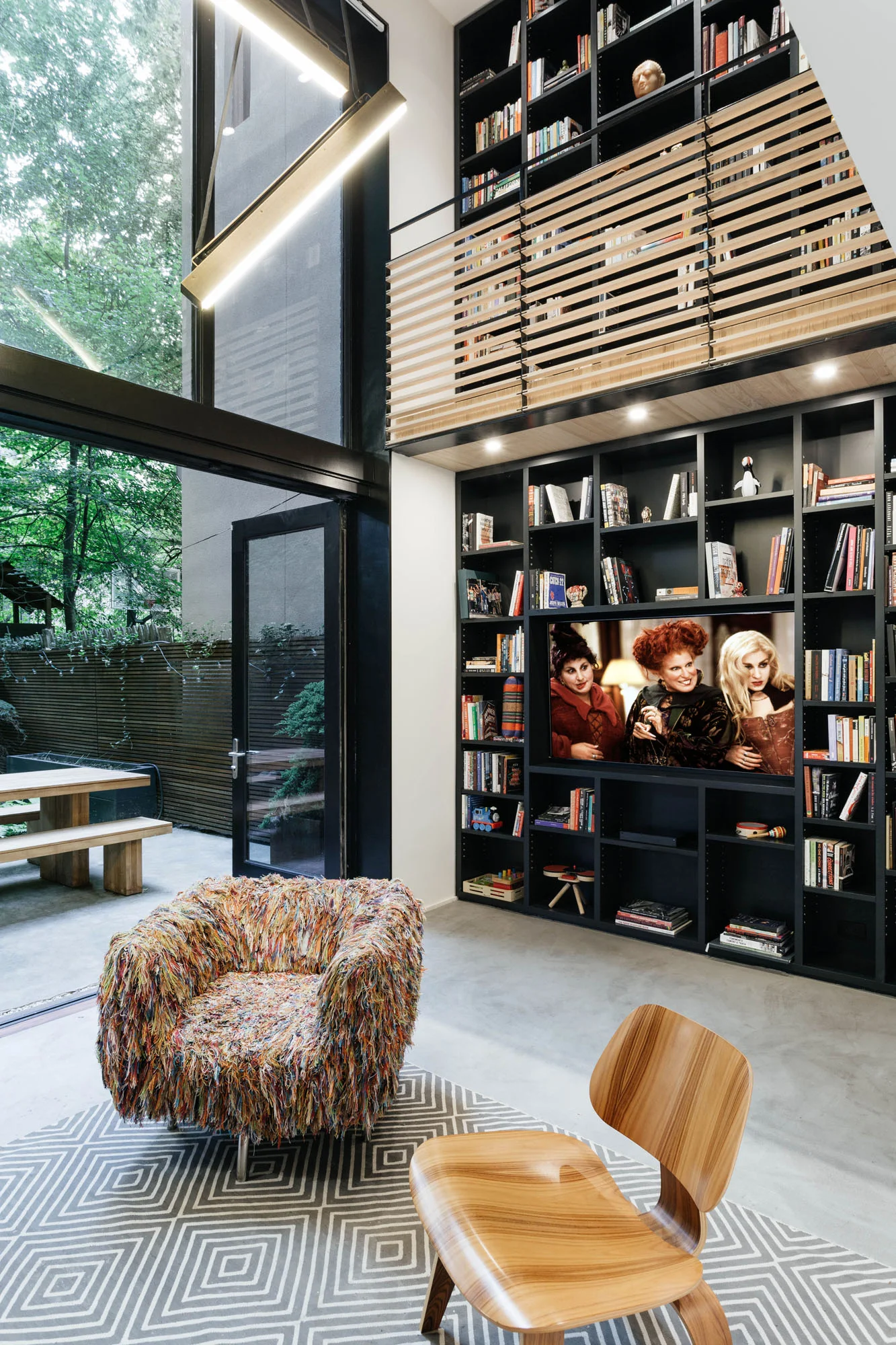   Development   The design of the library inverted to a black finish to anchor the space and hide the TV when off 