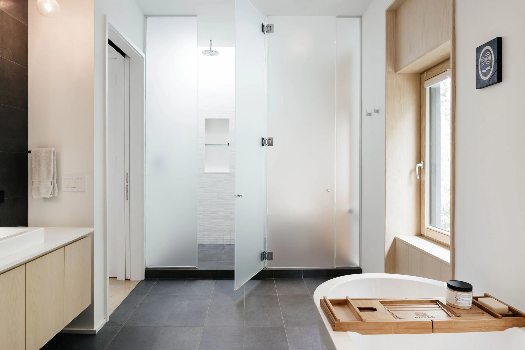 Separation an etched glass wall separates the shower and toilet while maintaining a soft airiness