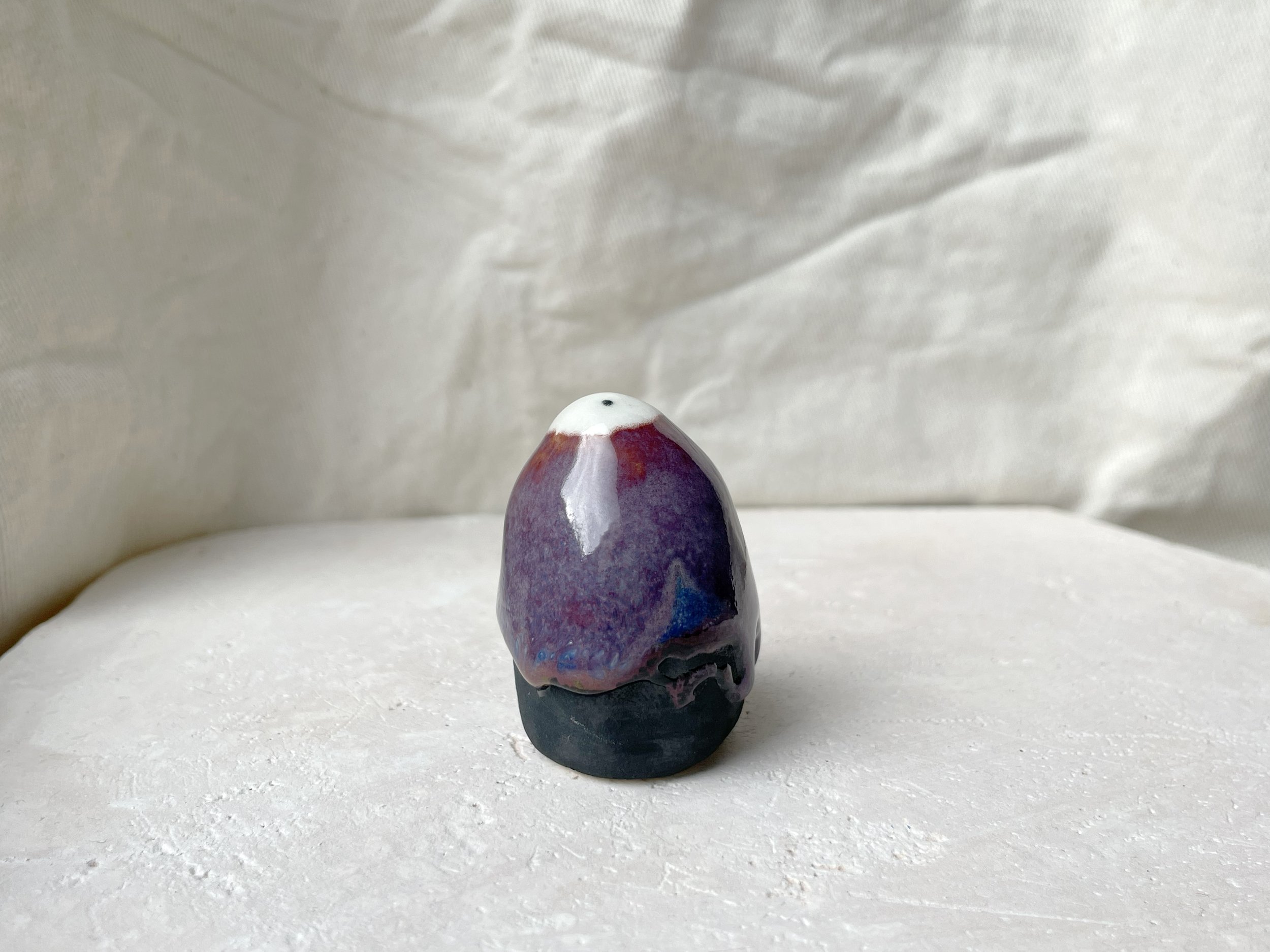 purple, black, blue handmade figurative ceramic sculpture with glossy floating glaze