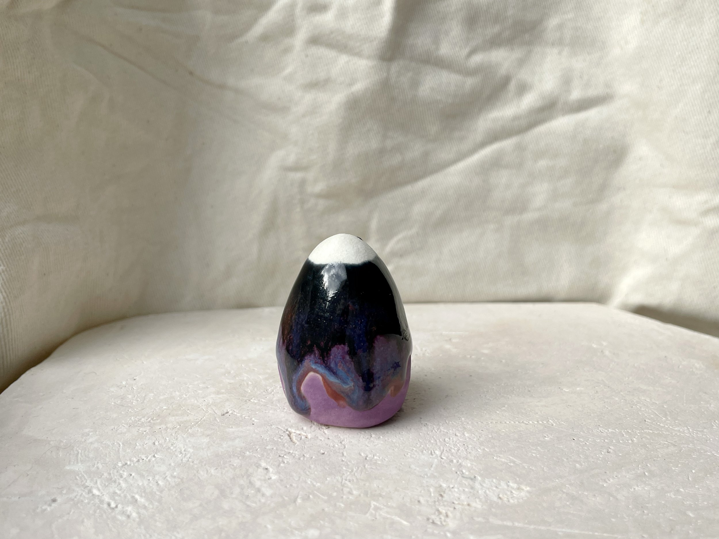 Purple, blue, red and black handmade figurative ceramic sculpture with glossy drippy floating glaze
