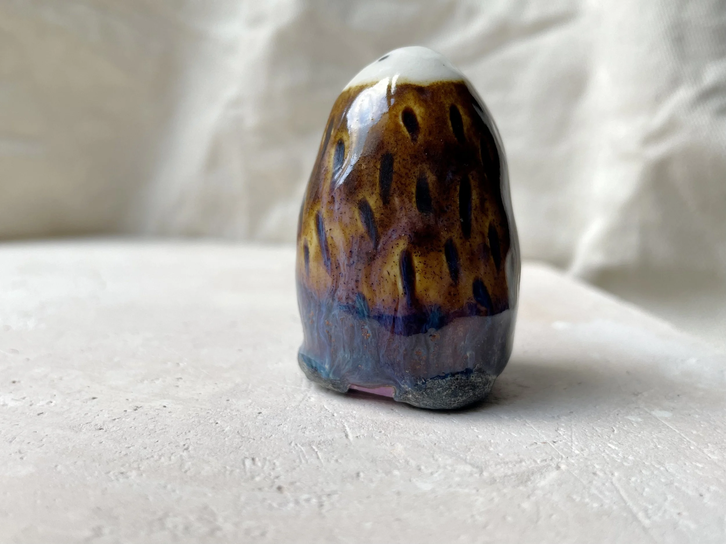 brown, purple and blue handmade figurative ceramic sculpture with underglaze and drippy float glaze