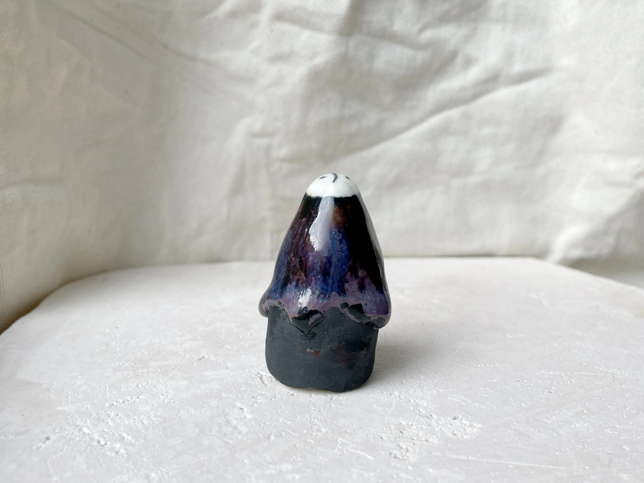 black, lilac and purple drippy handmade figurative ceramic sculpture with glossy floating glaze