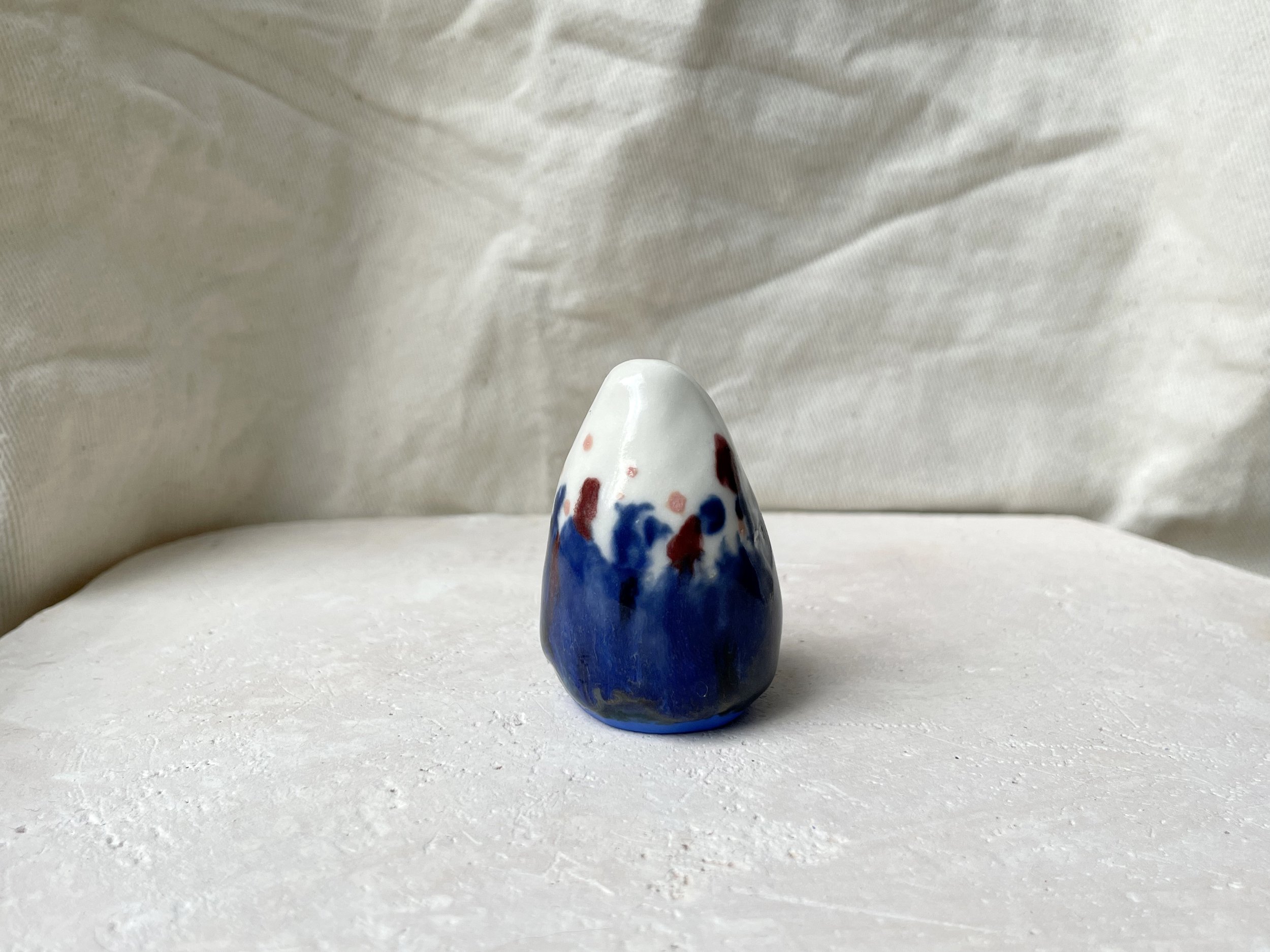 Blue, white, red and pink handmade figurative ceramic sculpture with glossy glaze and underglaze