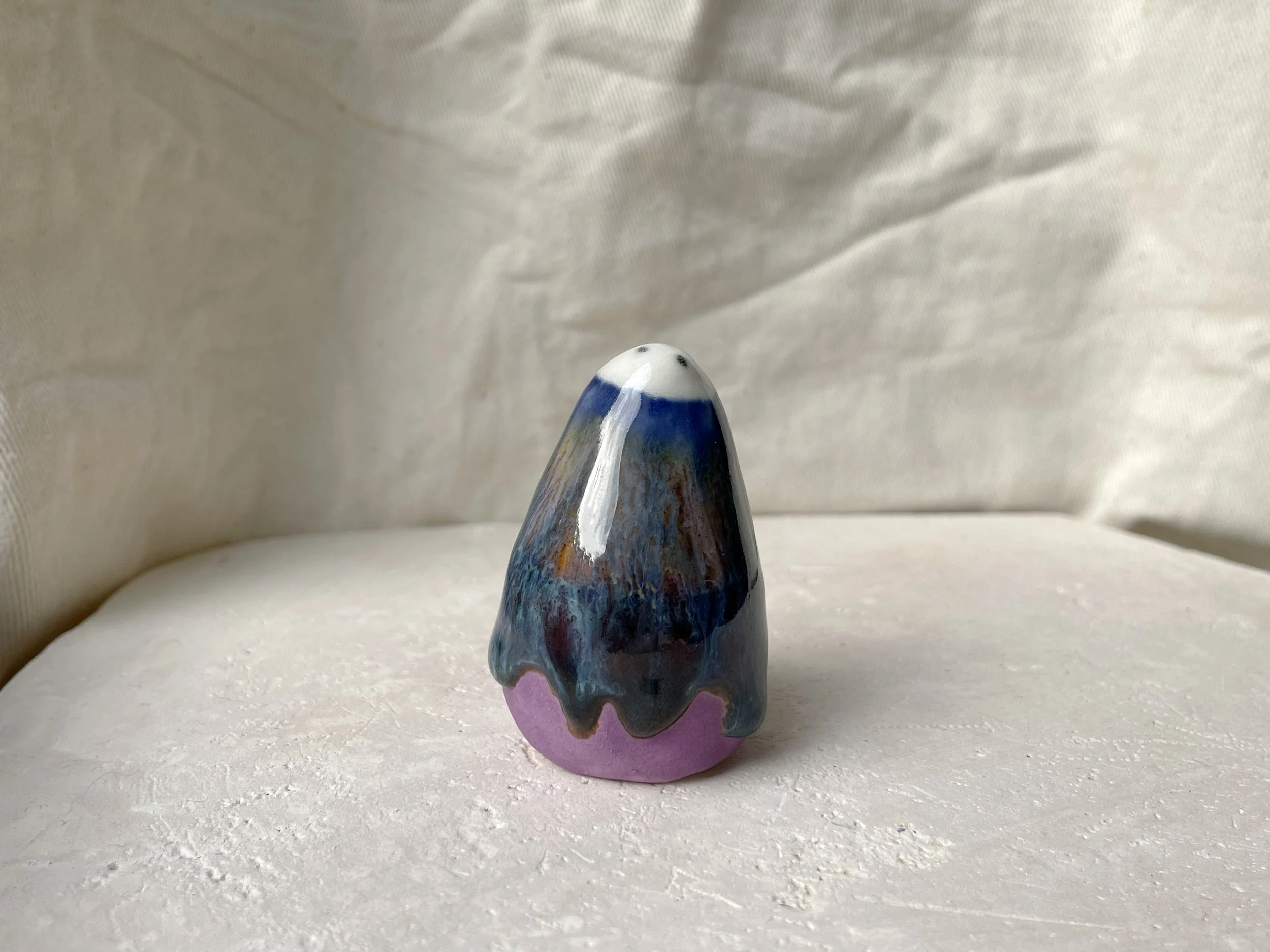 blue, orange, purple and red handmade figurative ceramic sculpture with glossy drippy floating glaze