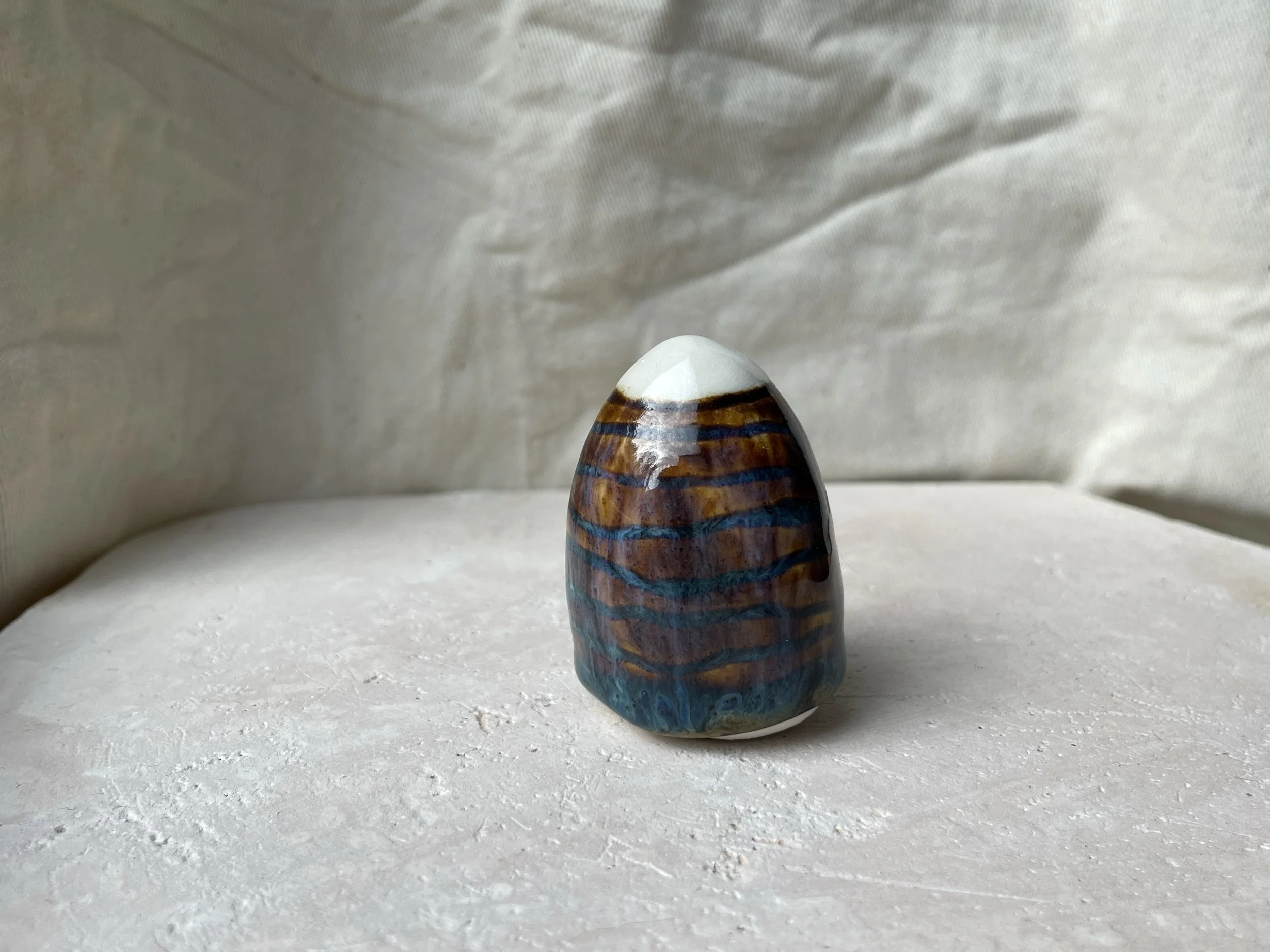 Brown and blue handmade figurative ceramic sculpture with underglaze and runny glaze