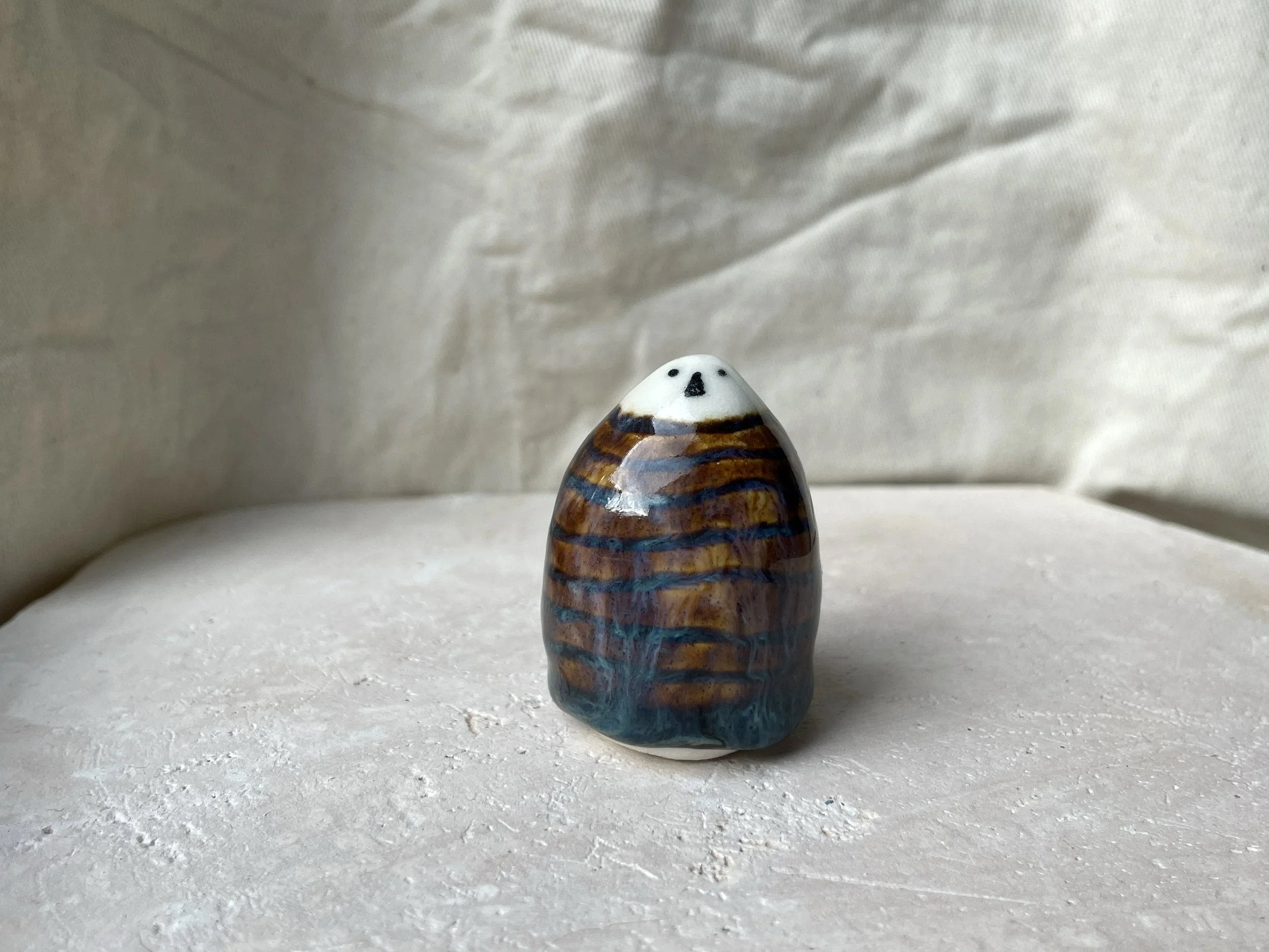 Brown and blue handmade figurative ceramic sculpture with underglaze and runny glaze