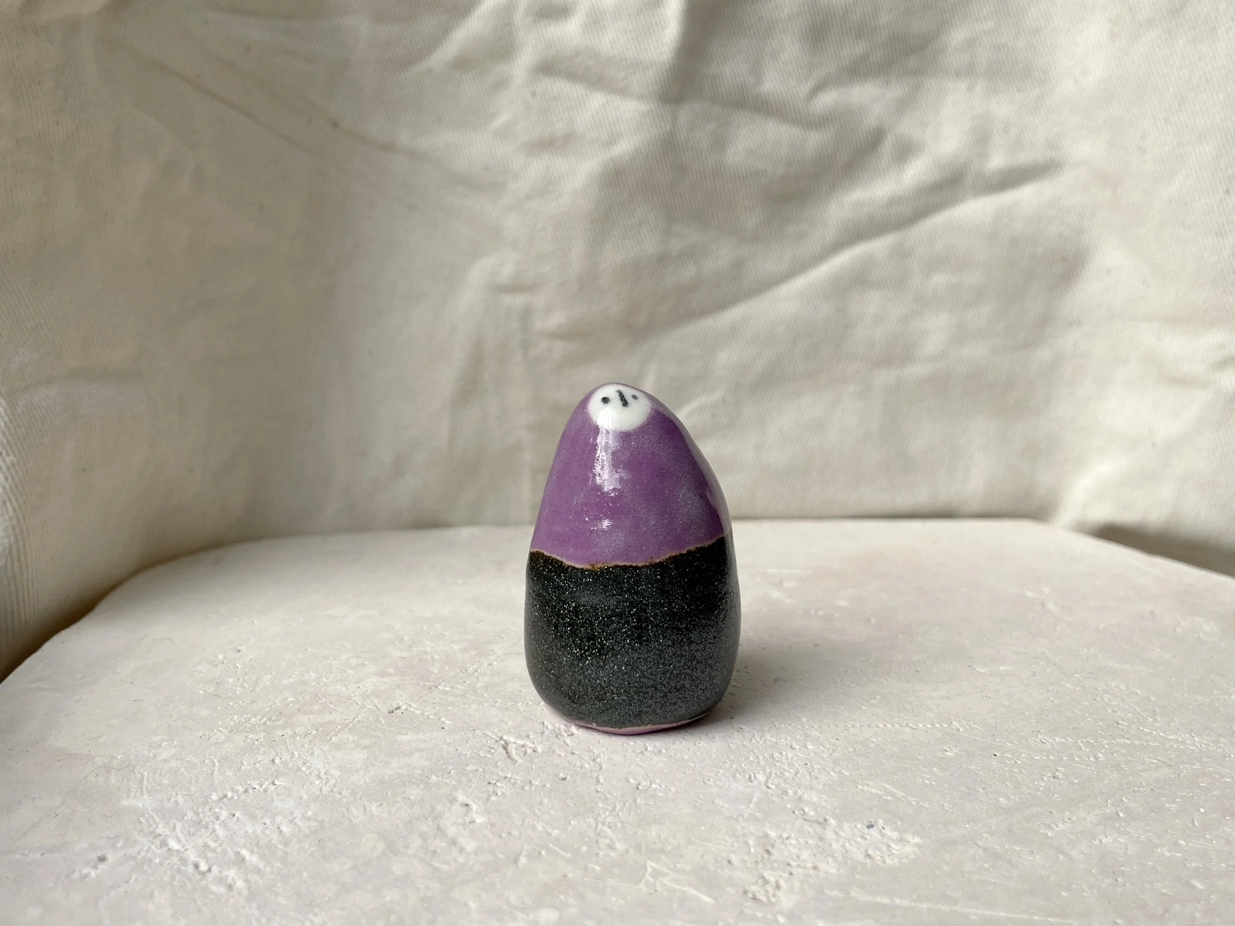 Purple and sparkly black handmade figurative ceramic sculpture with underglaze and glaze