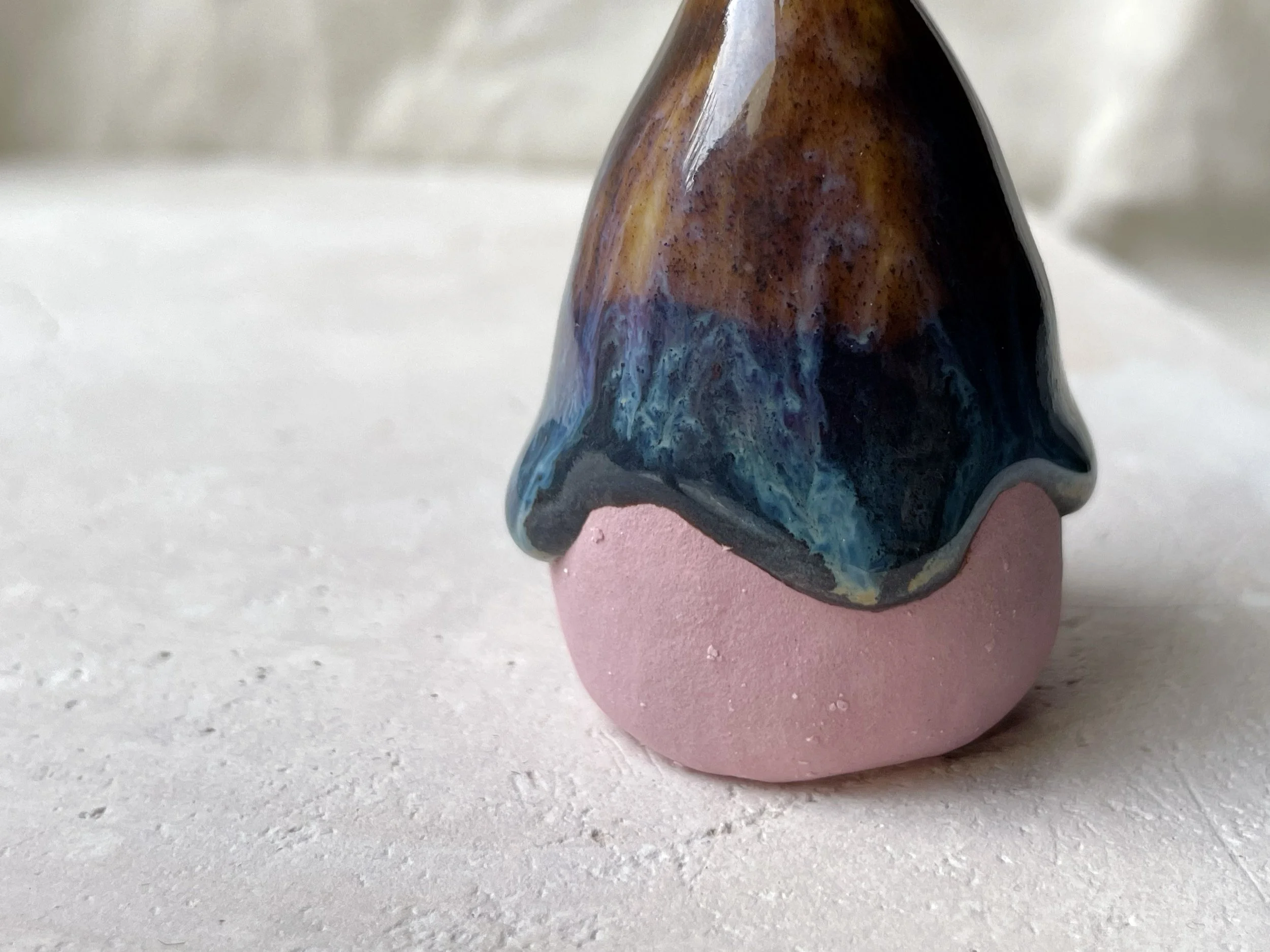 pink, brown and green handmade figurative ceramic sculpture with underglaze and drippy runny glaze