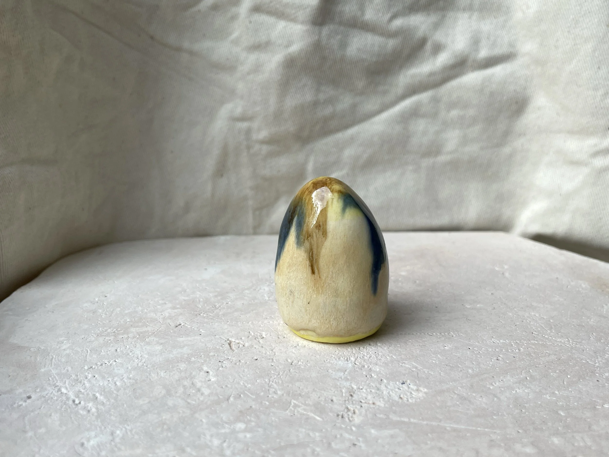 Yellow, brown, blue and cream handmade figurative ceramic sculpture with glossy drippy glaze