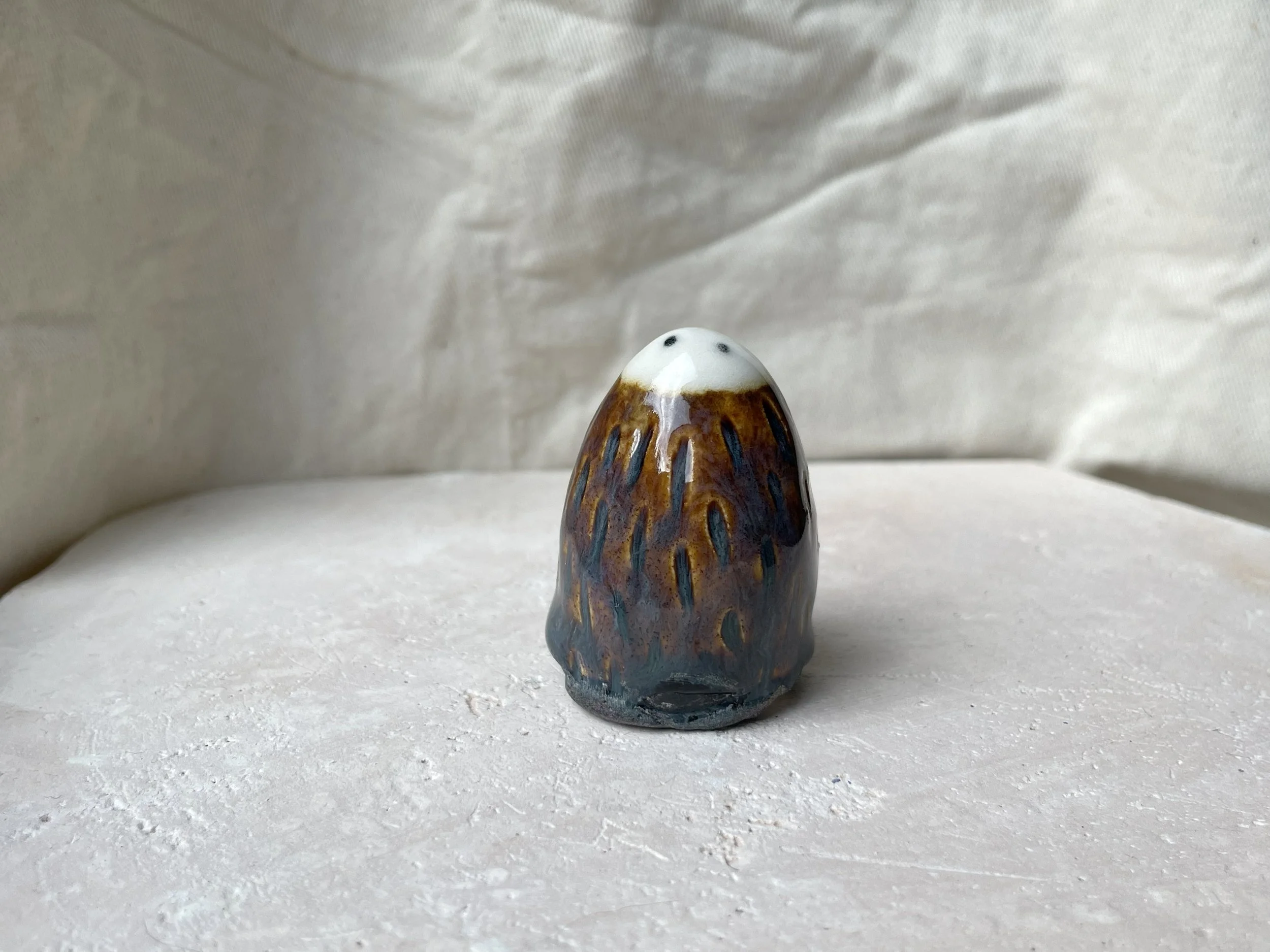 Brown. blue and black handmade figurative ceramic sculpture with underglaze and floating glaze