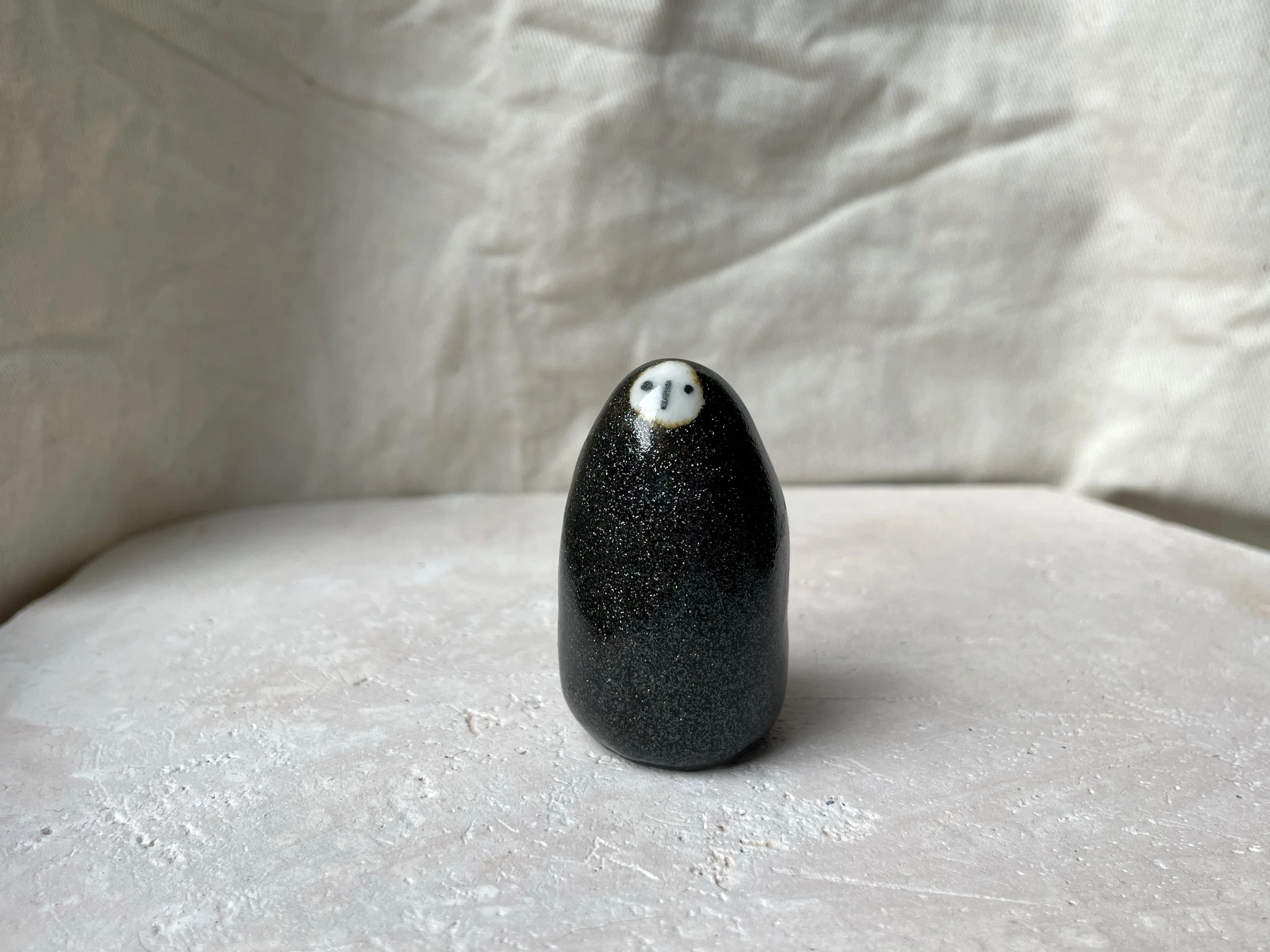 black sparkly handmade figurative ceramic sculpture with glittery glaze