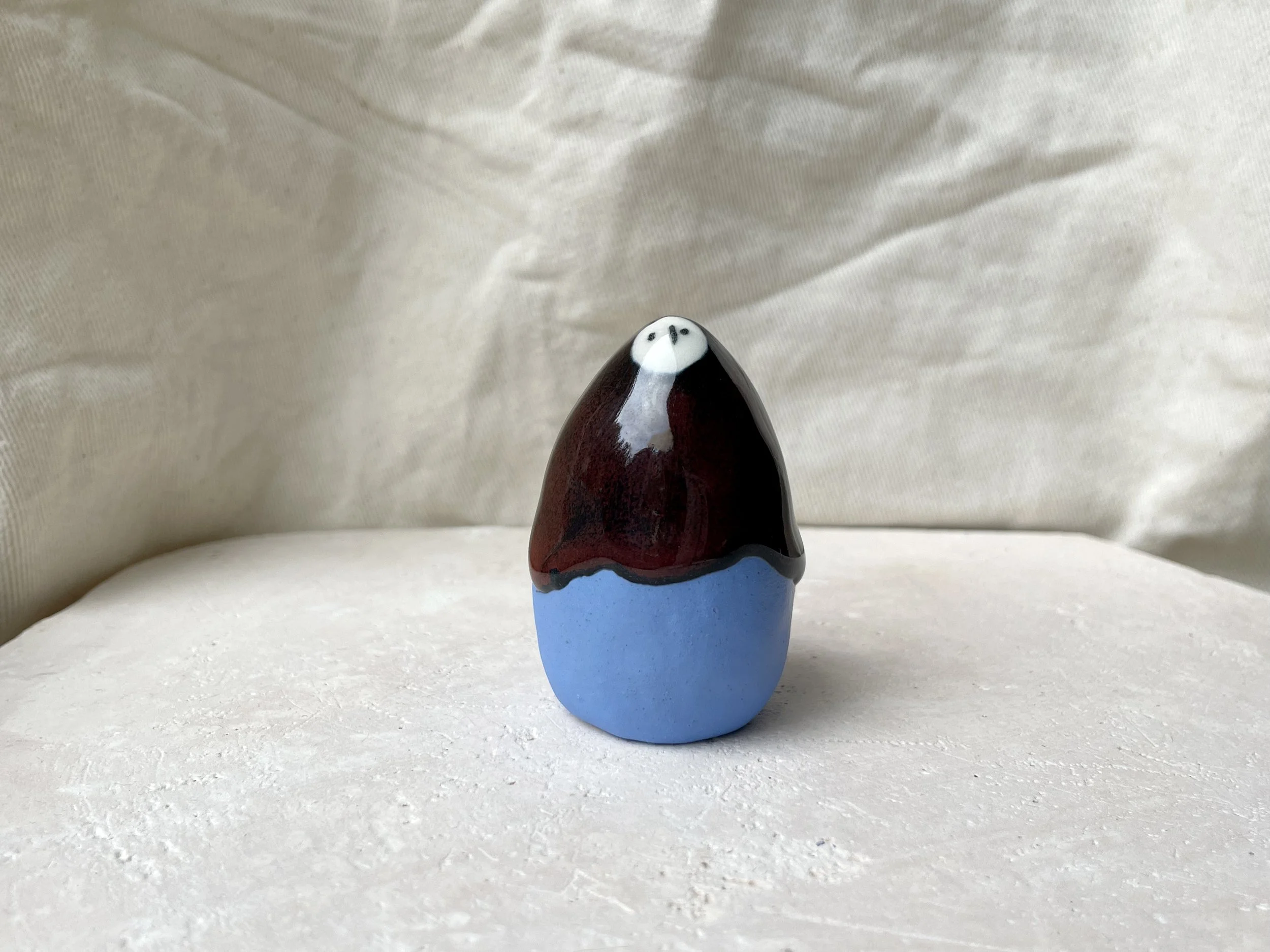 Blue, red and black handmade figurative ceramic sculpture with underglaze and drippy float glaze