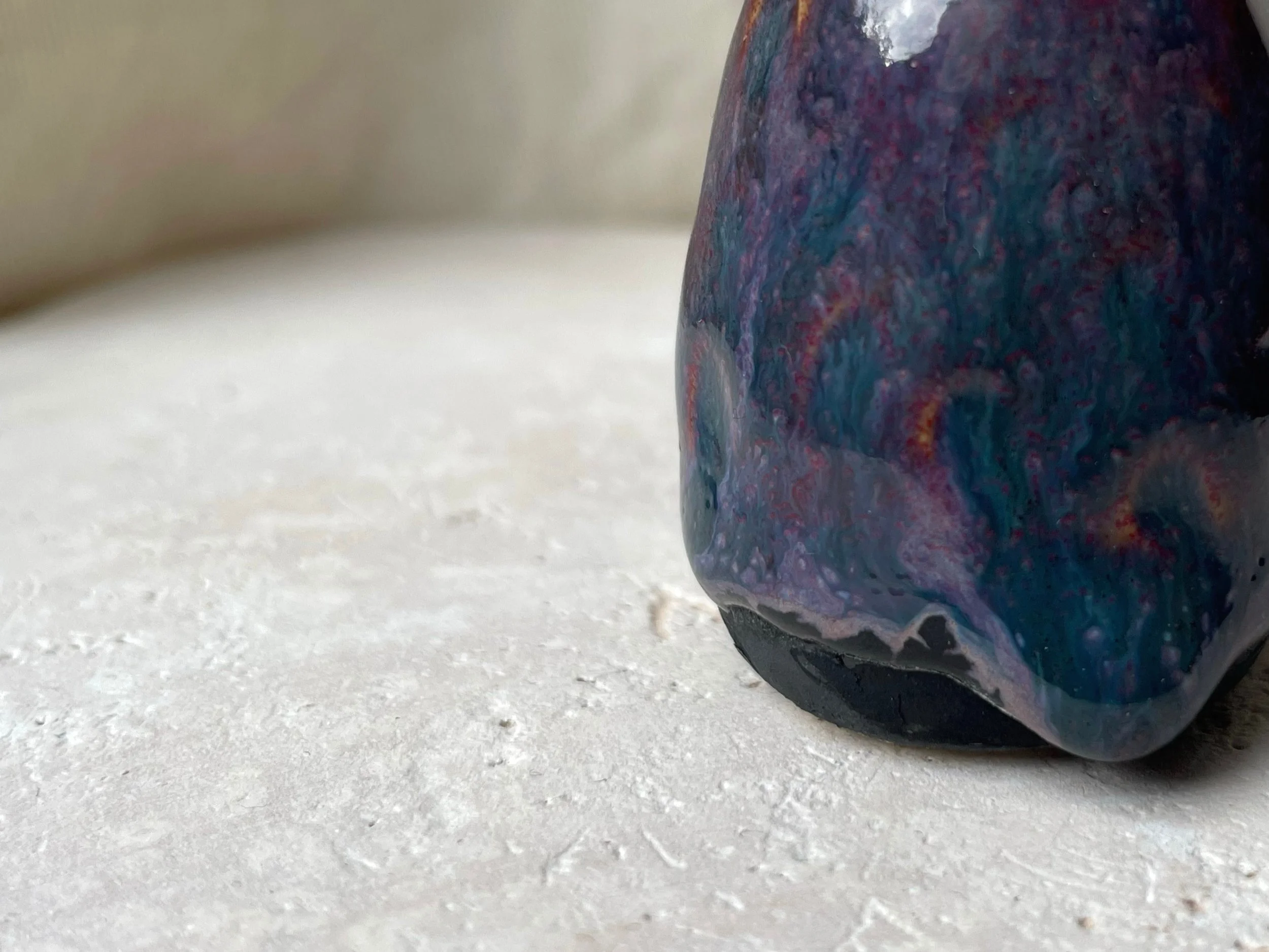 Purple, black and red handmade figurative ceramic sculpture with underglaze and floating glaze