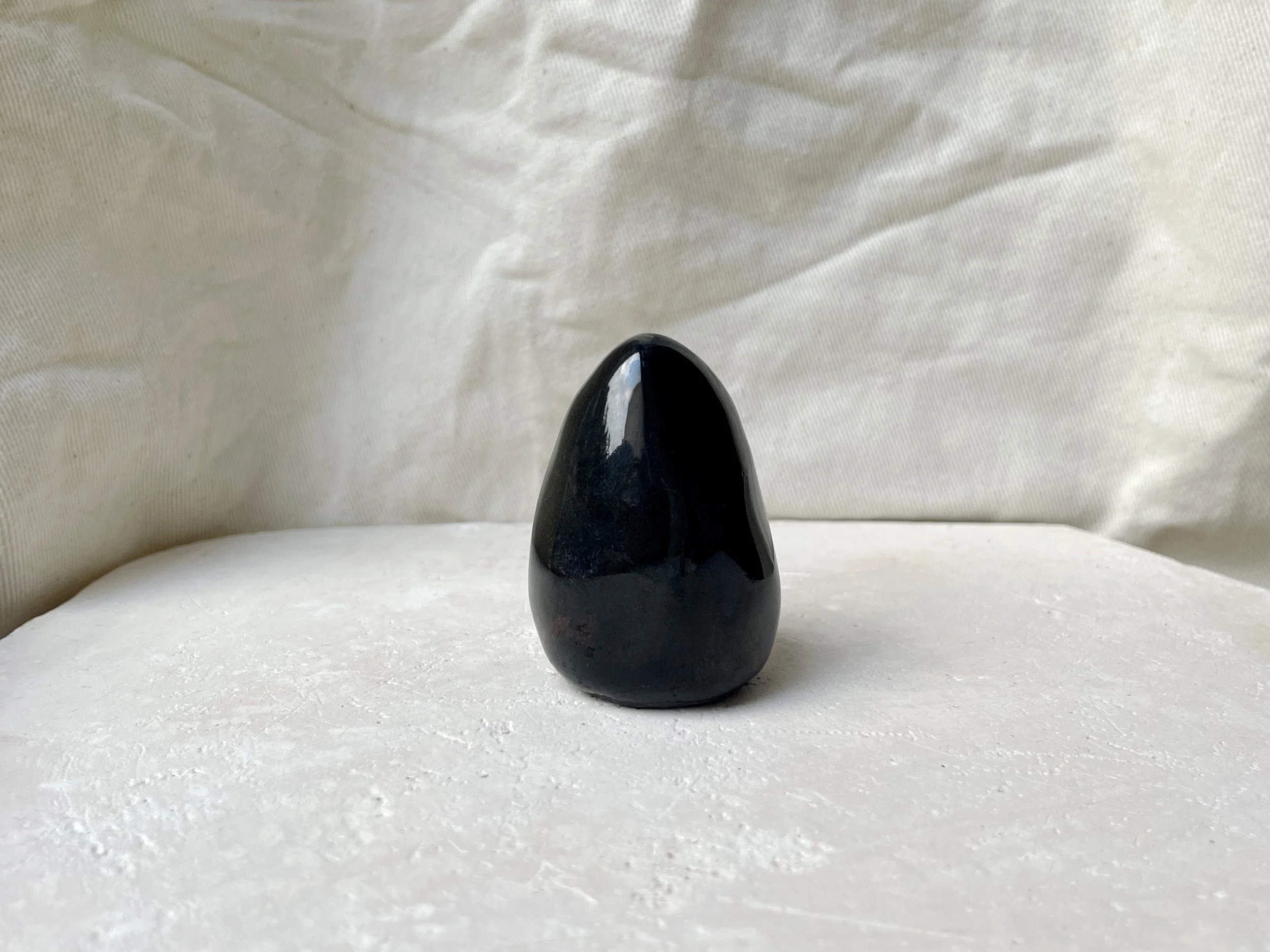 Black red and blue handmade figurative ceramic sculpture with glossy floating glaze