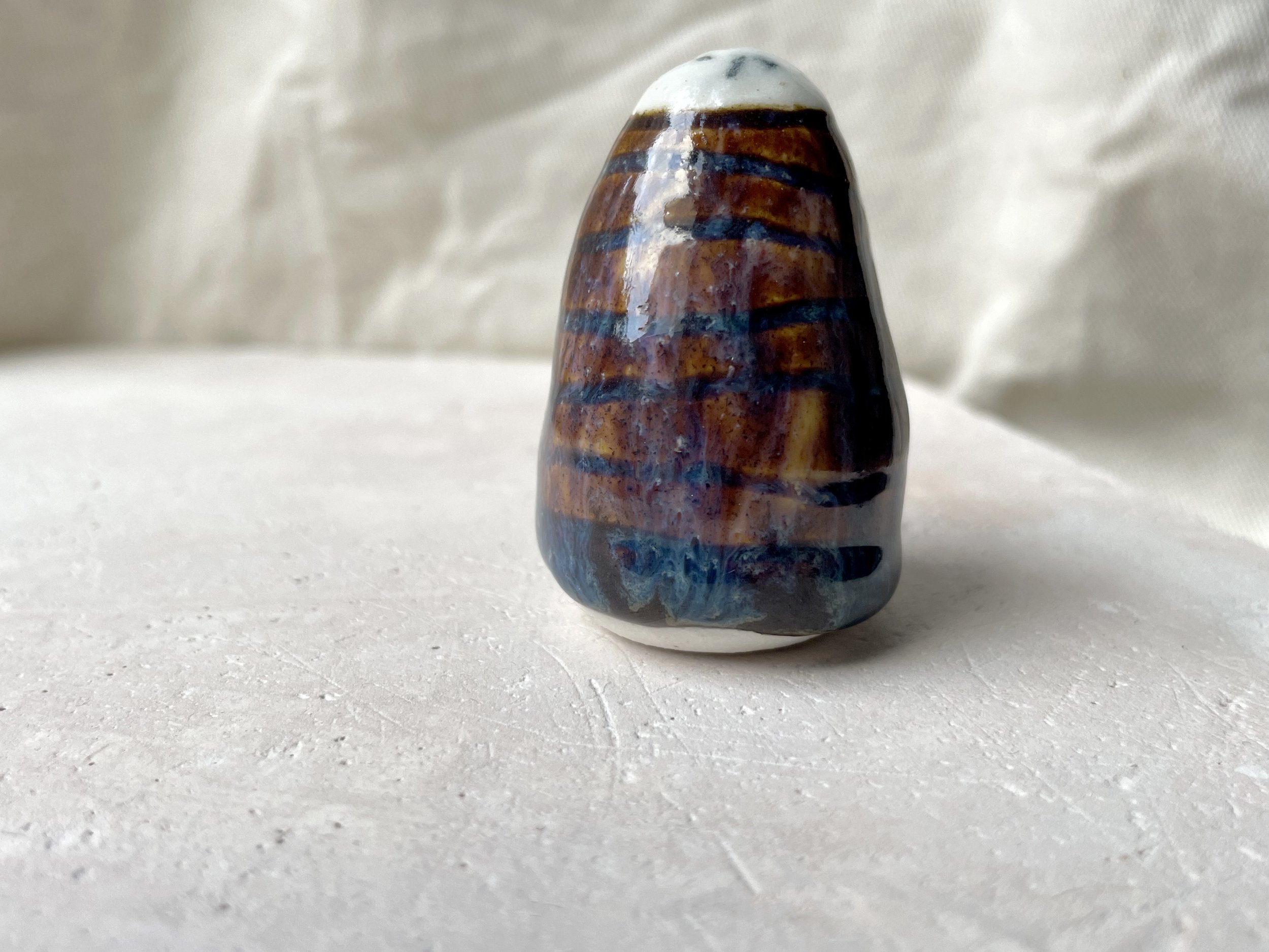 brown, purple and blue handmade figurative ceramic sculpture with underglaze and drippy float glaze