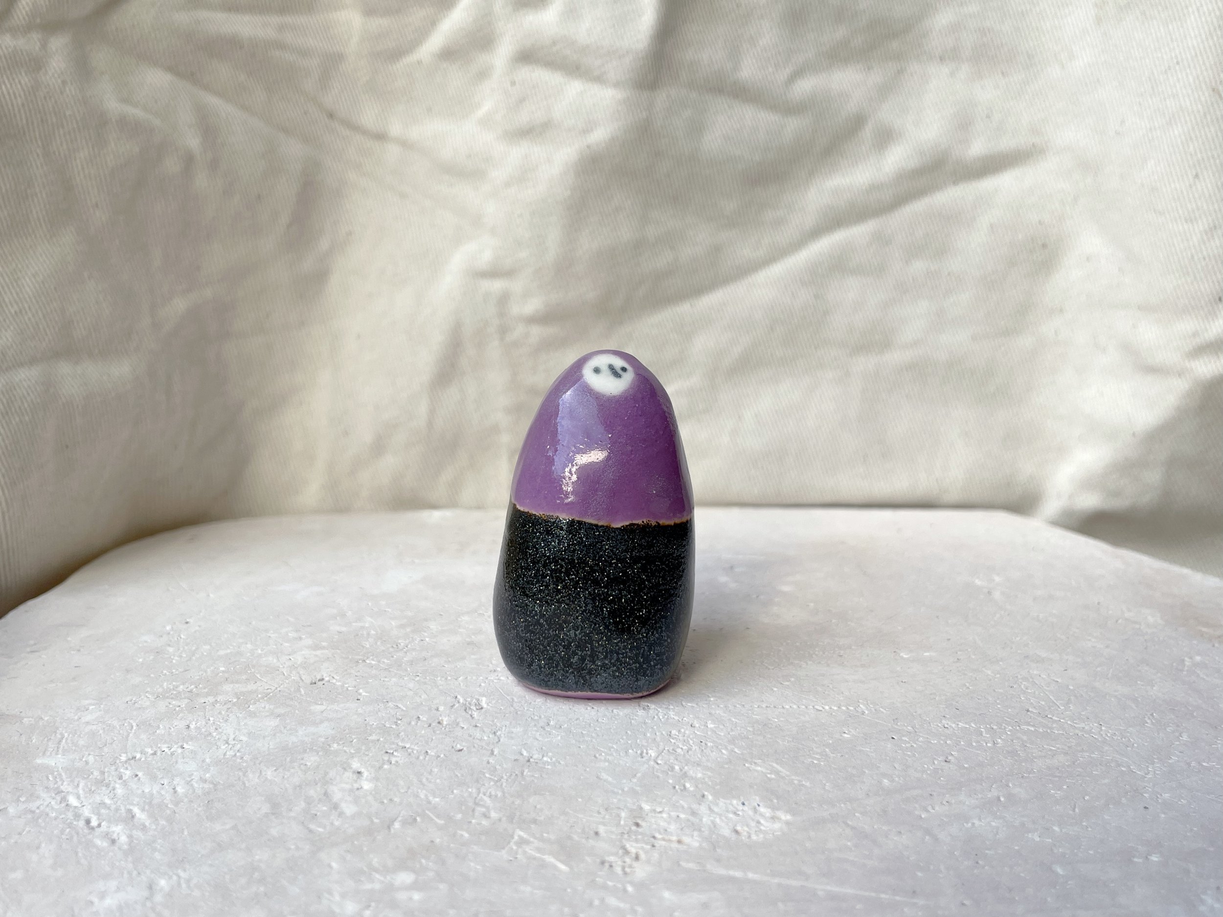 Purple and black sparkly handmade figurative ceramic sculpture with glittery glaze