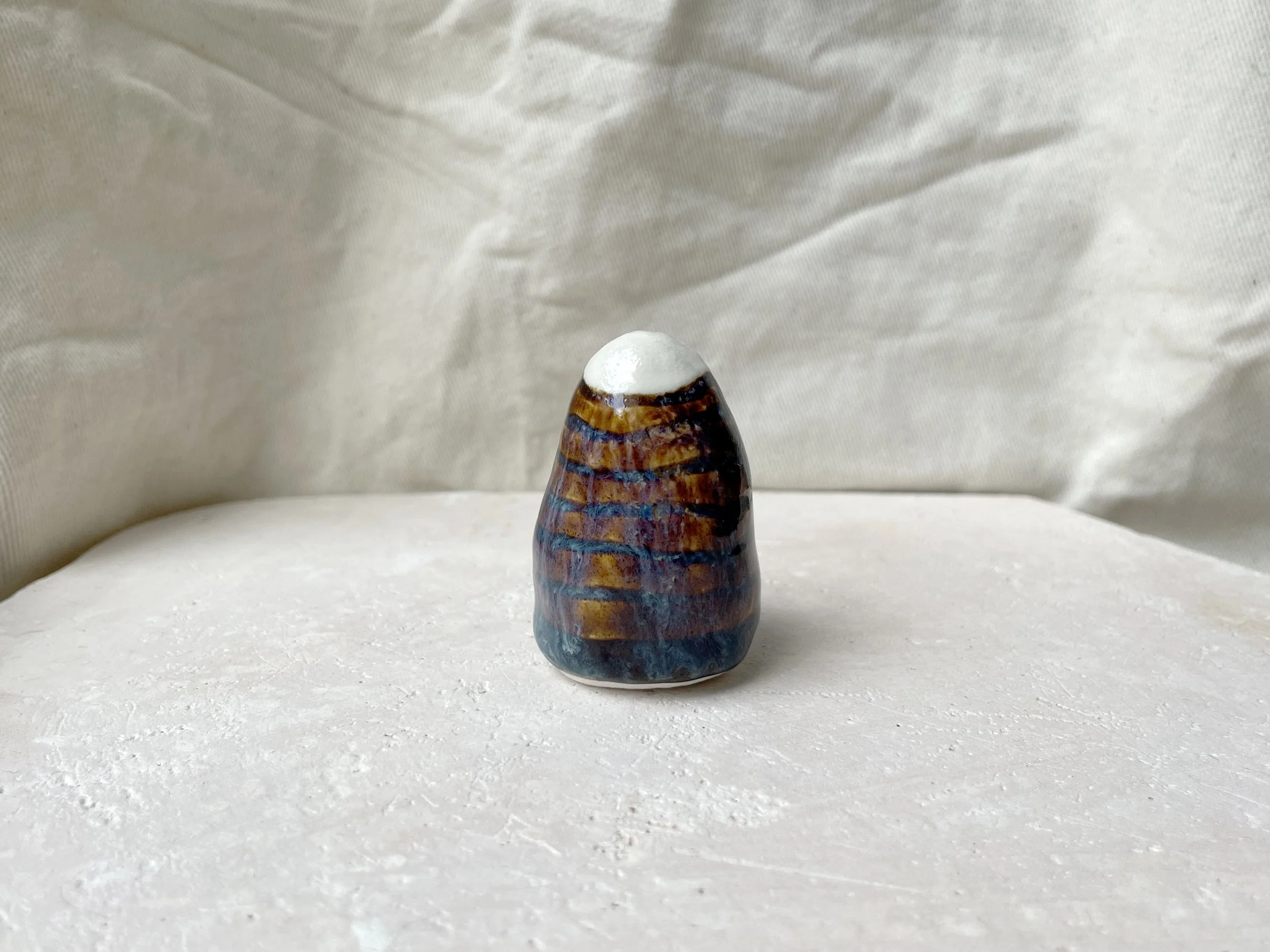 brown, purple and blue handmade figurative ceramic sculpture with underglaze and drippy float glaze