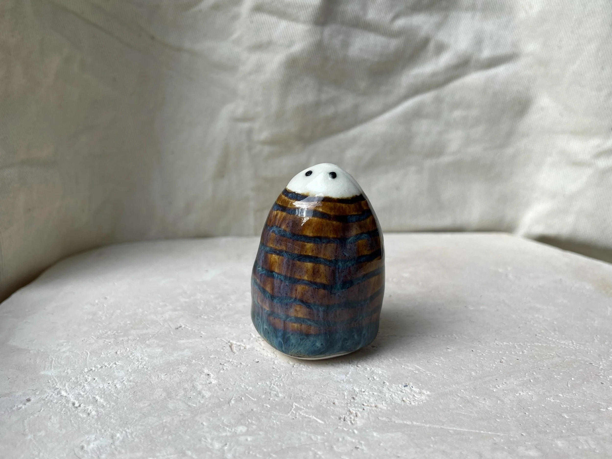 Brown and blue handmade figurative ceramic sculpture with underglaze and runny glaze