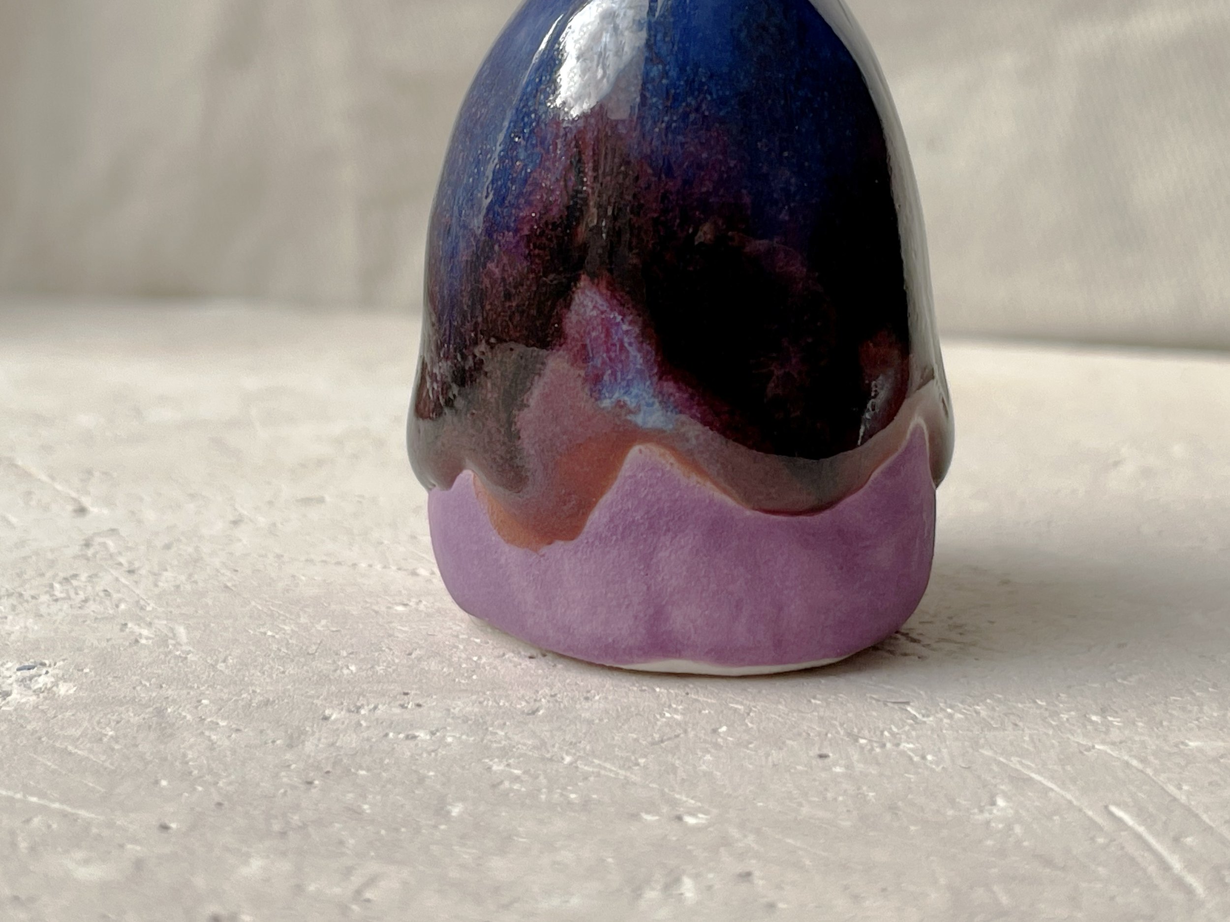 Purple, blue and red handmade figurative ceramic sculpture with glossy drippy floating glaze