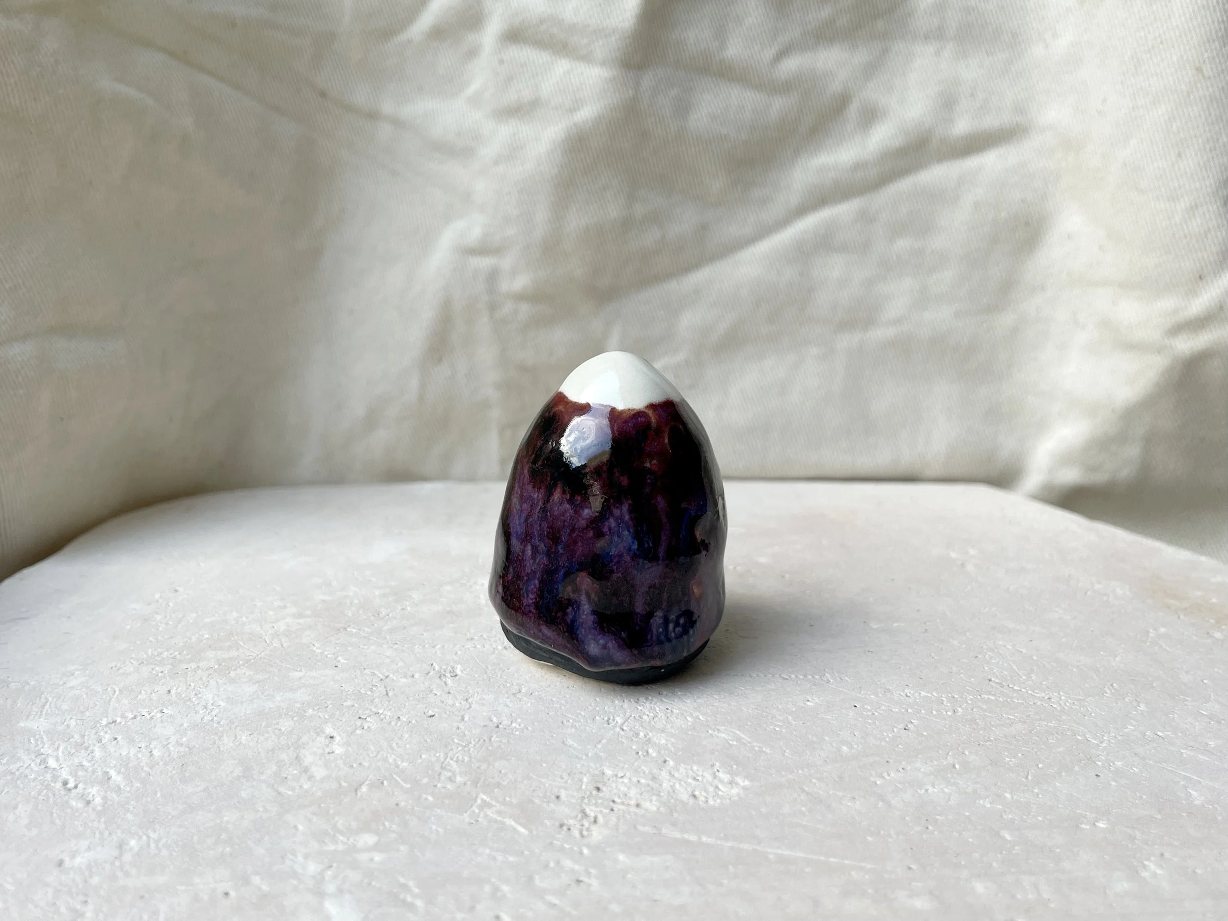 Purple, black and blue handmade figurative ceramic sculpture with underglaze and drippy float glaze