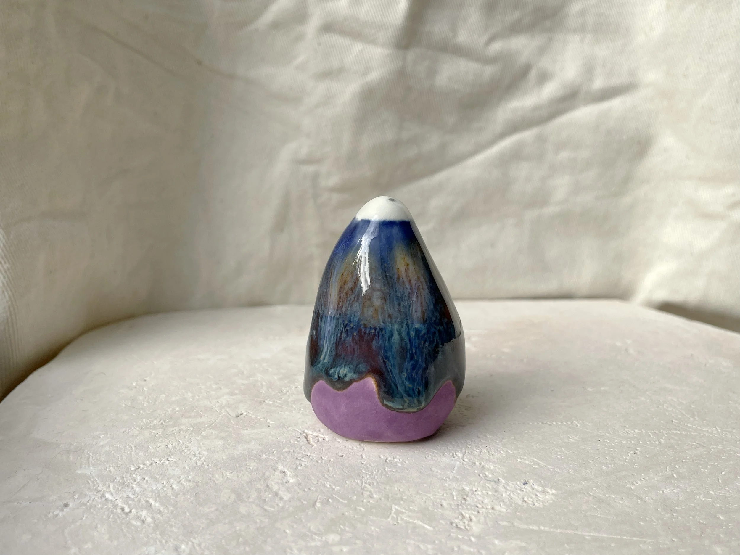 blue, orange, purple and red handmade figurative ceramic sculpture with glossy drippy floating glaze