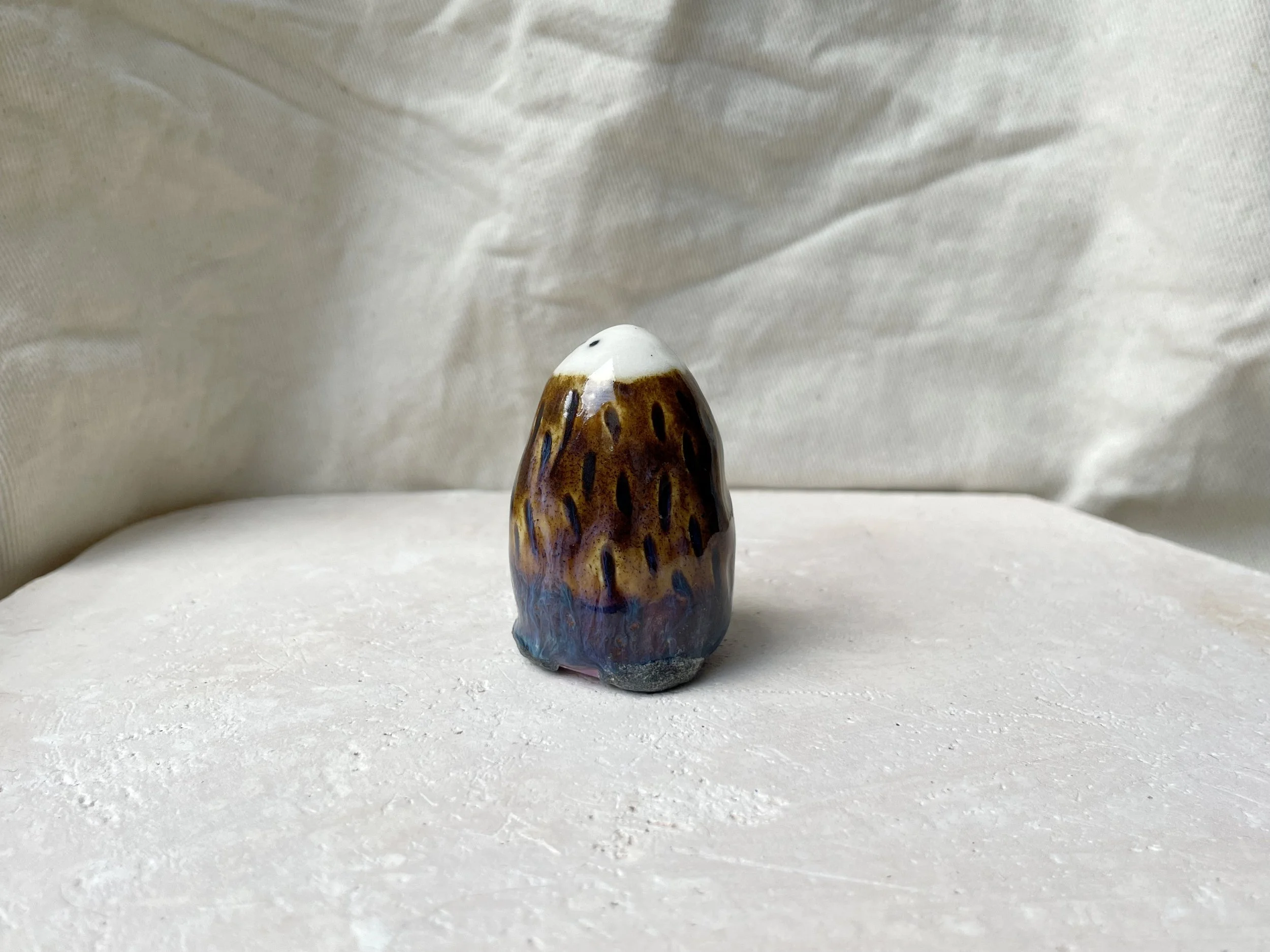 brown, purple and blue handmade figurative ceramic sculpture with underglaze and drippy float glaze