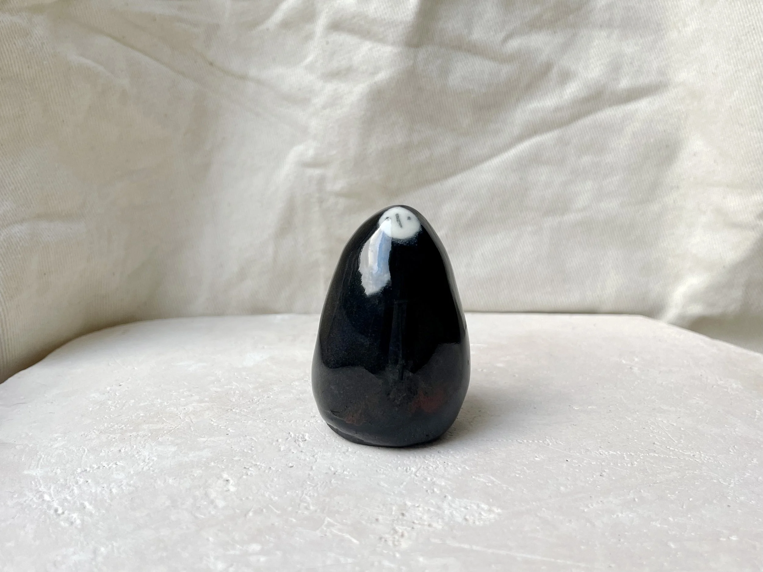 Black red and blue handmade figurative ceramic sculpture with glossy floating glaze