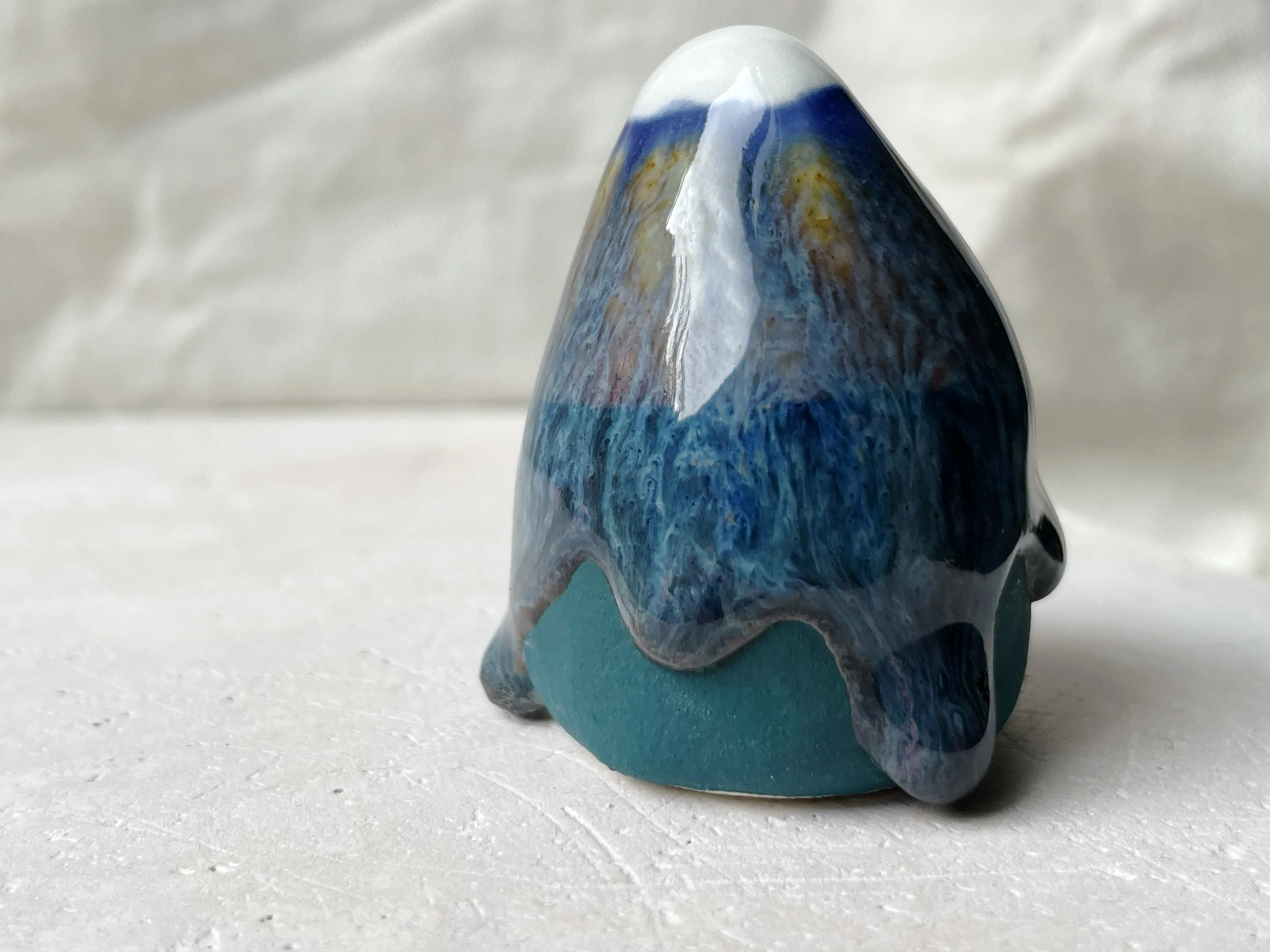 Blue and green handmade figurative ceramic sculpture with underglaze and runny glaze